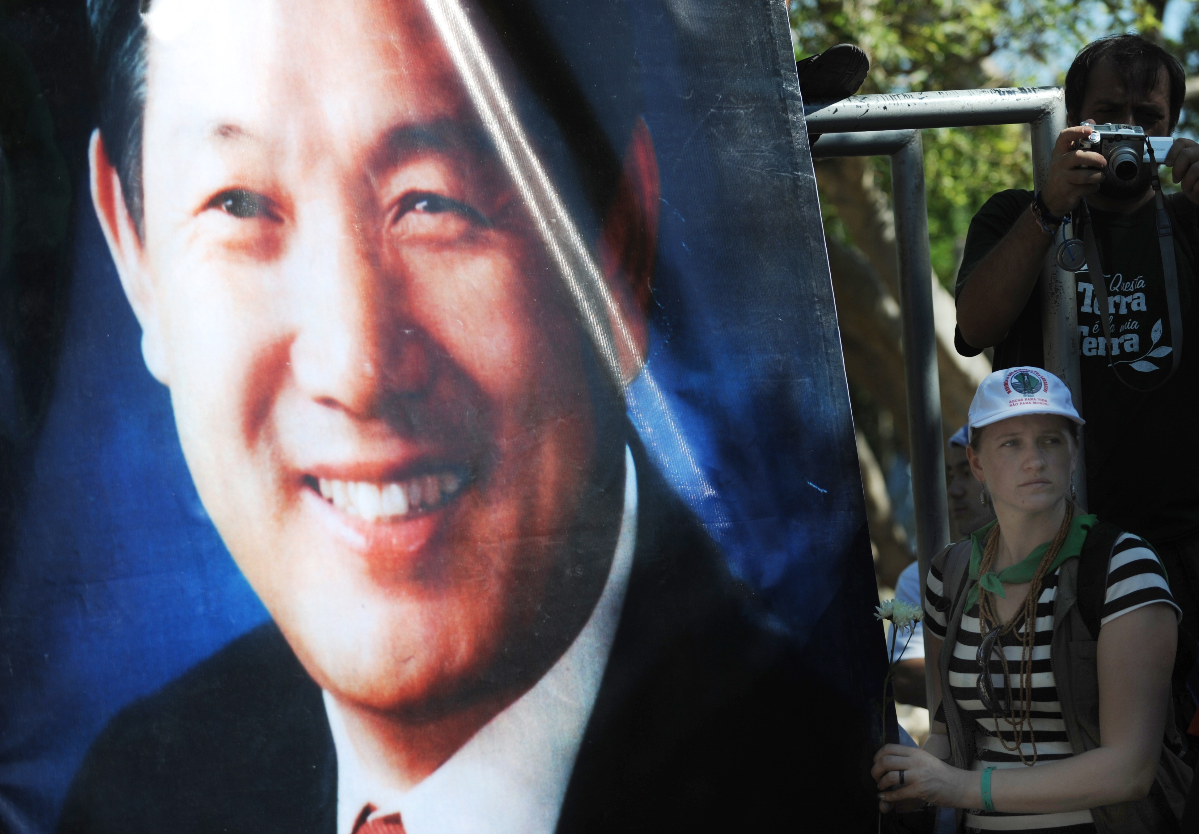 A protesters holds a banner-sized photo of Lee Kyung-Hae