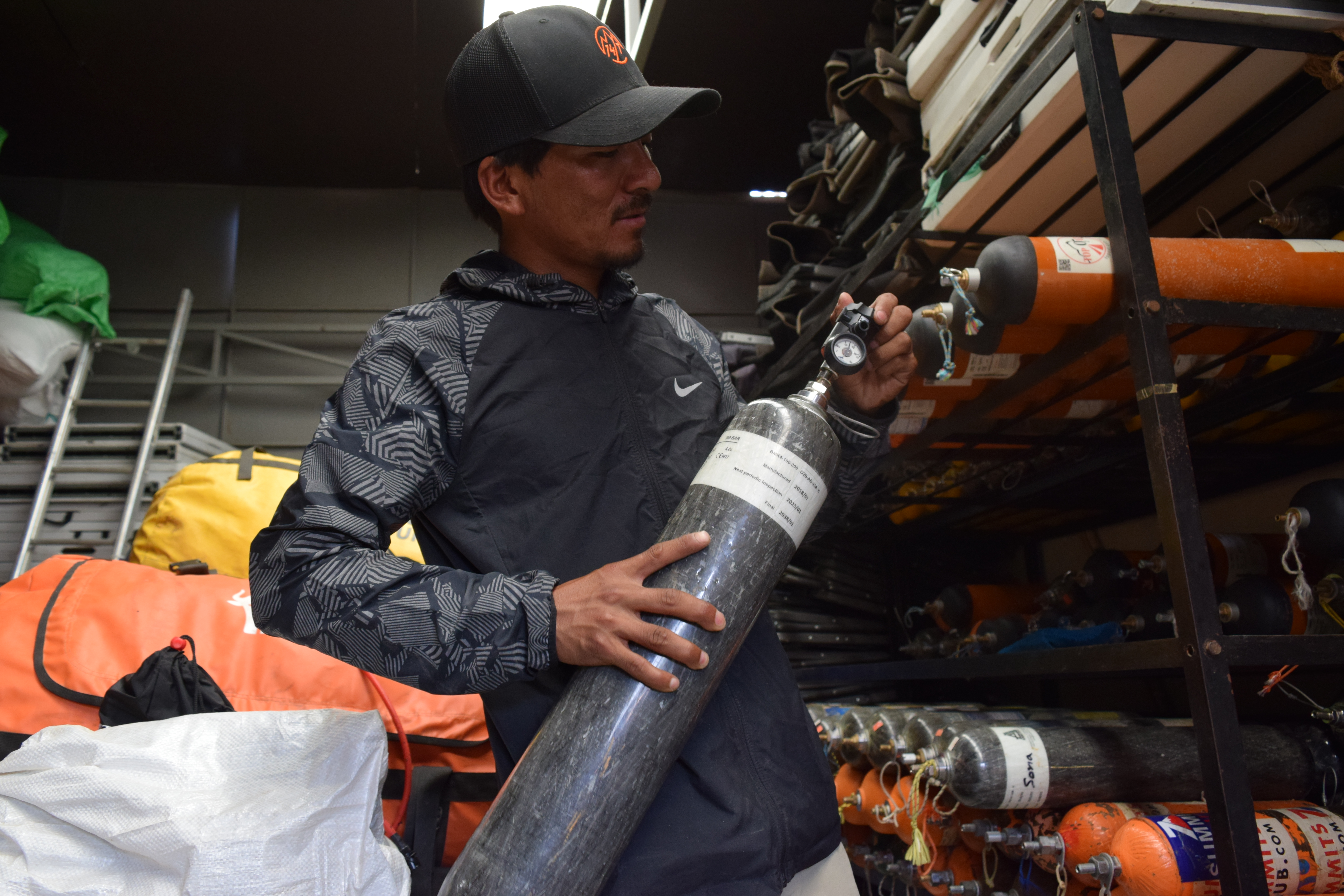 1568620655254-Mountain-guide-and-rescue-specialist-Mingma-David-Sherpa-checking-an-oxygen-cylinder