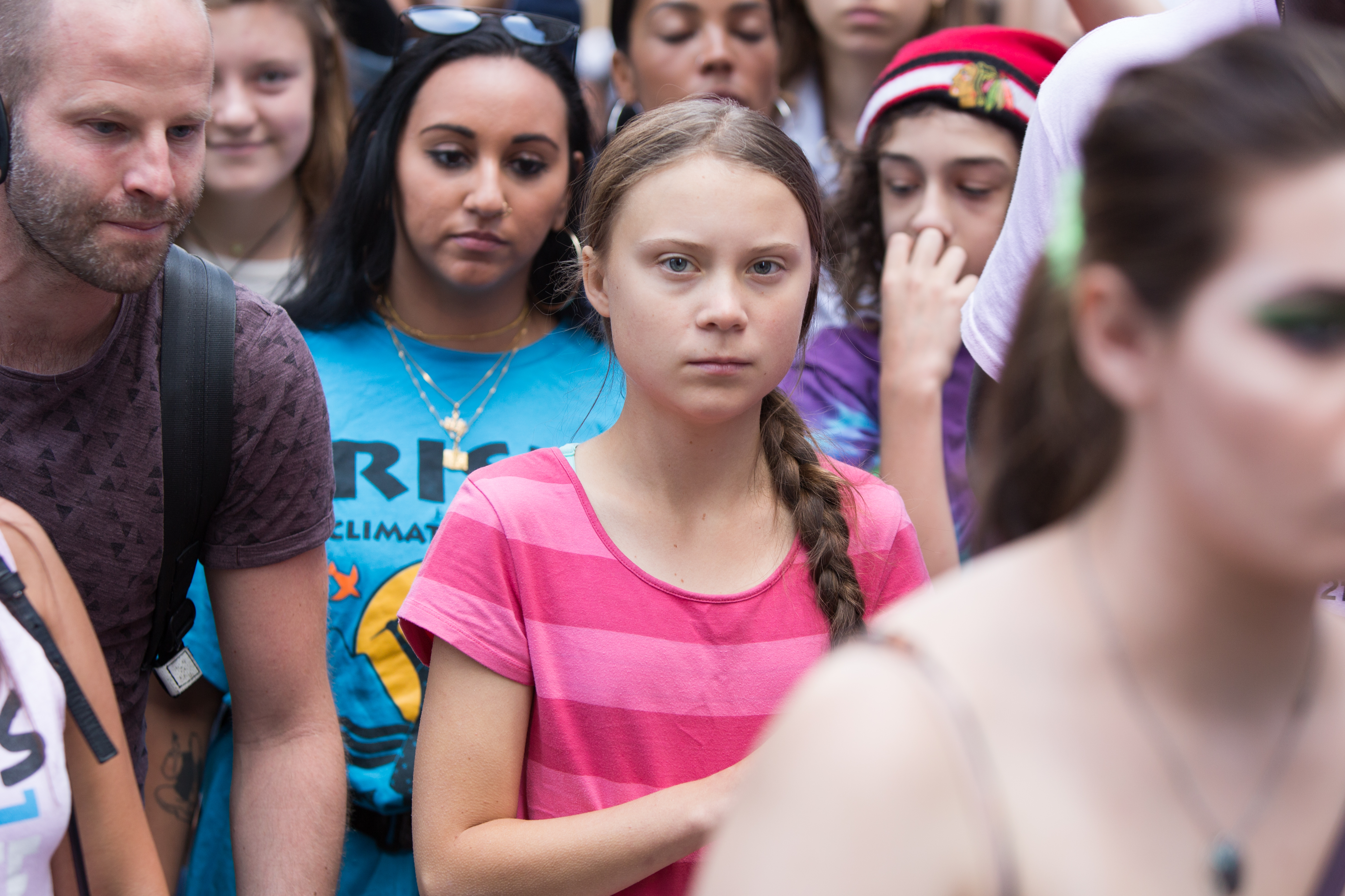 Greta Thunberg surrounded by climate marchers.