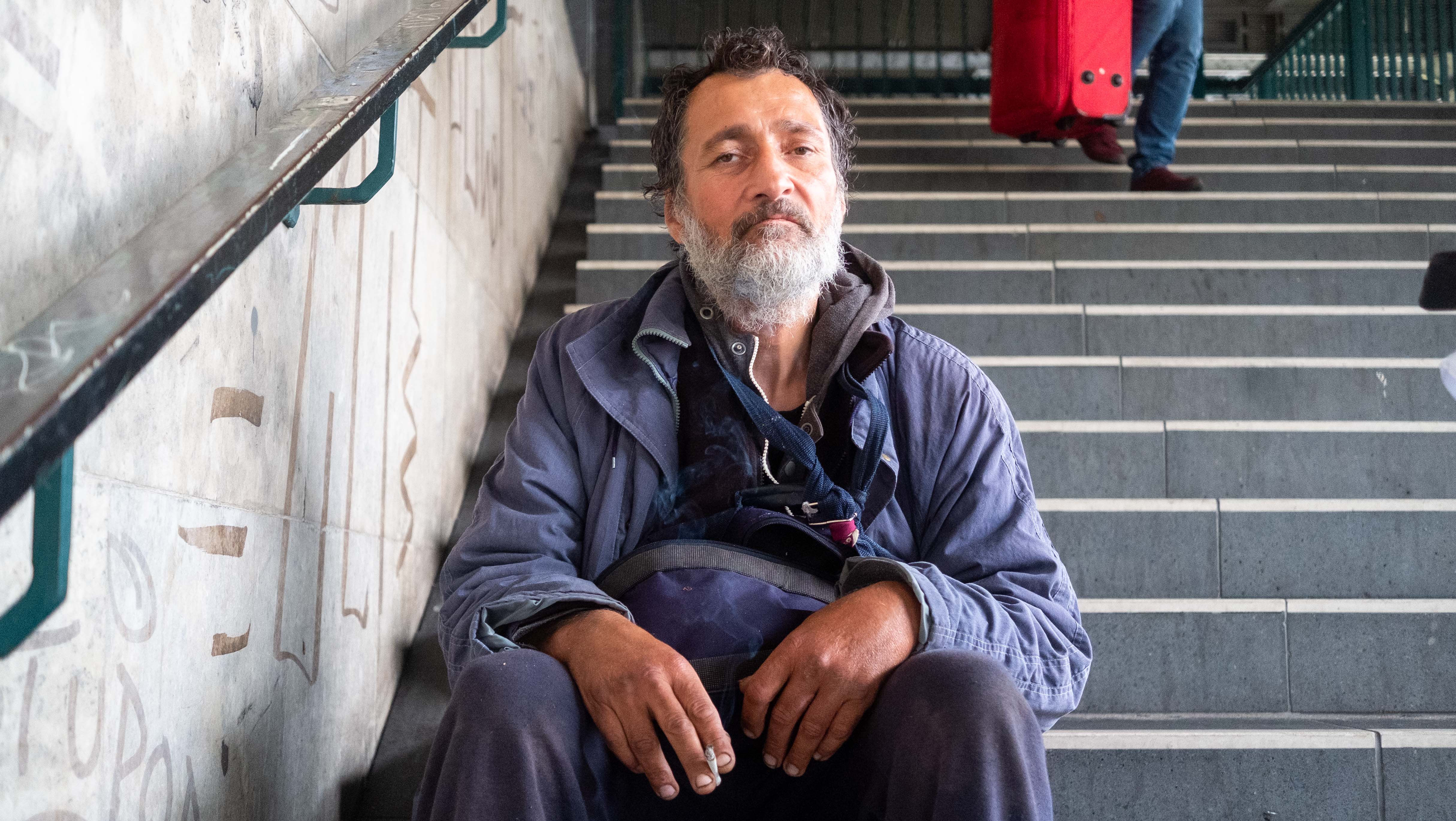 Ein Mann mit Zigarette auf einer Treppe in Berlin