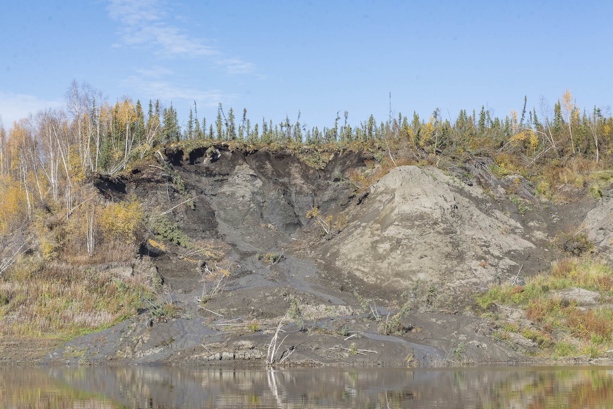 On the banks of the Porcupine 160 km upriver is a giant mudslide, a result of melting permafrost.