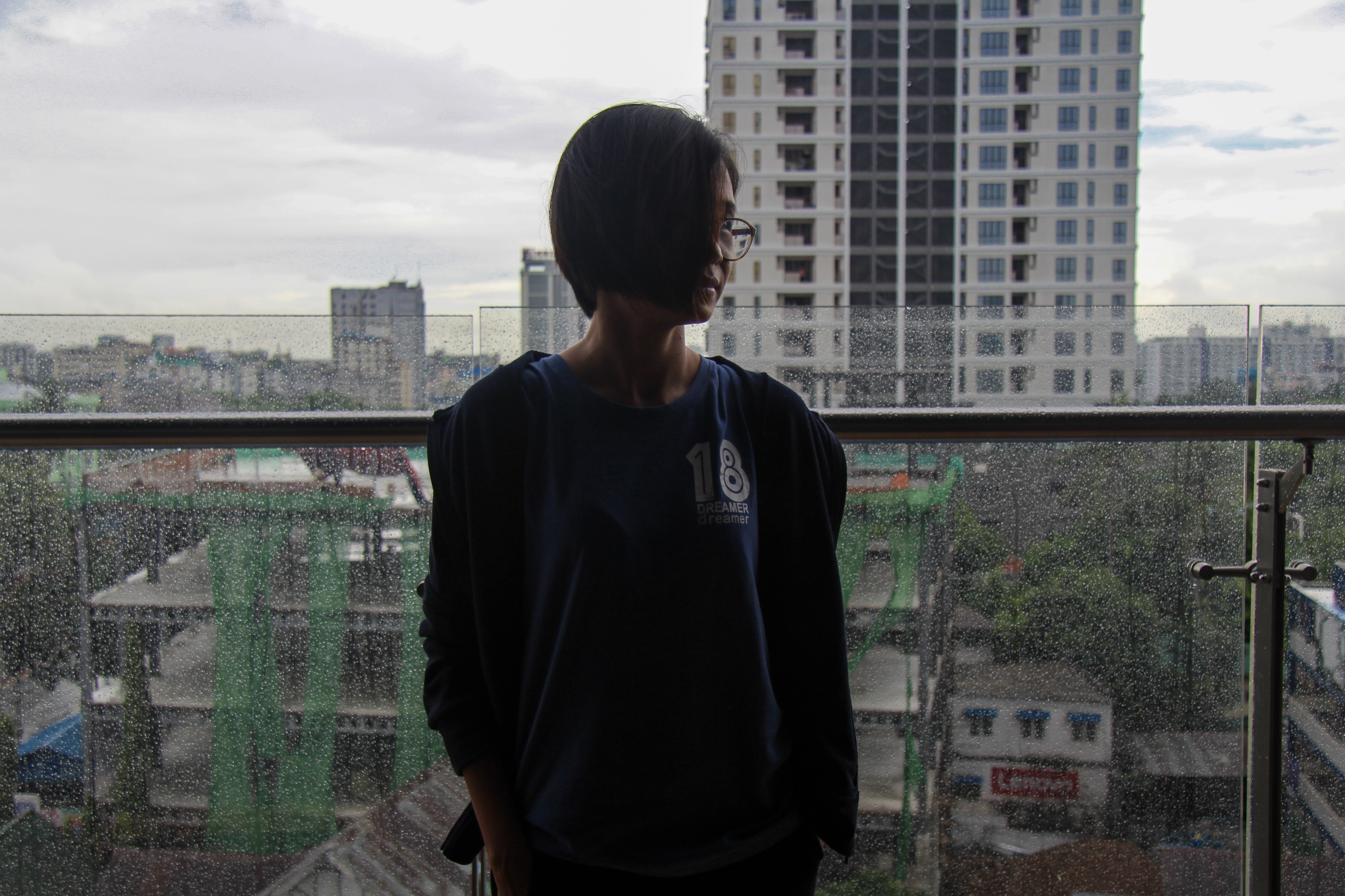1569918633079-Zinmin-Thu-stands-against-the-Yangon-skyline-in-June-2019-2