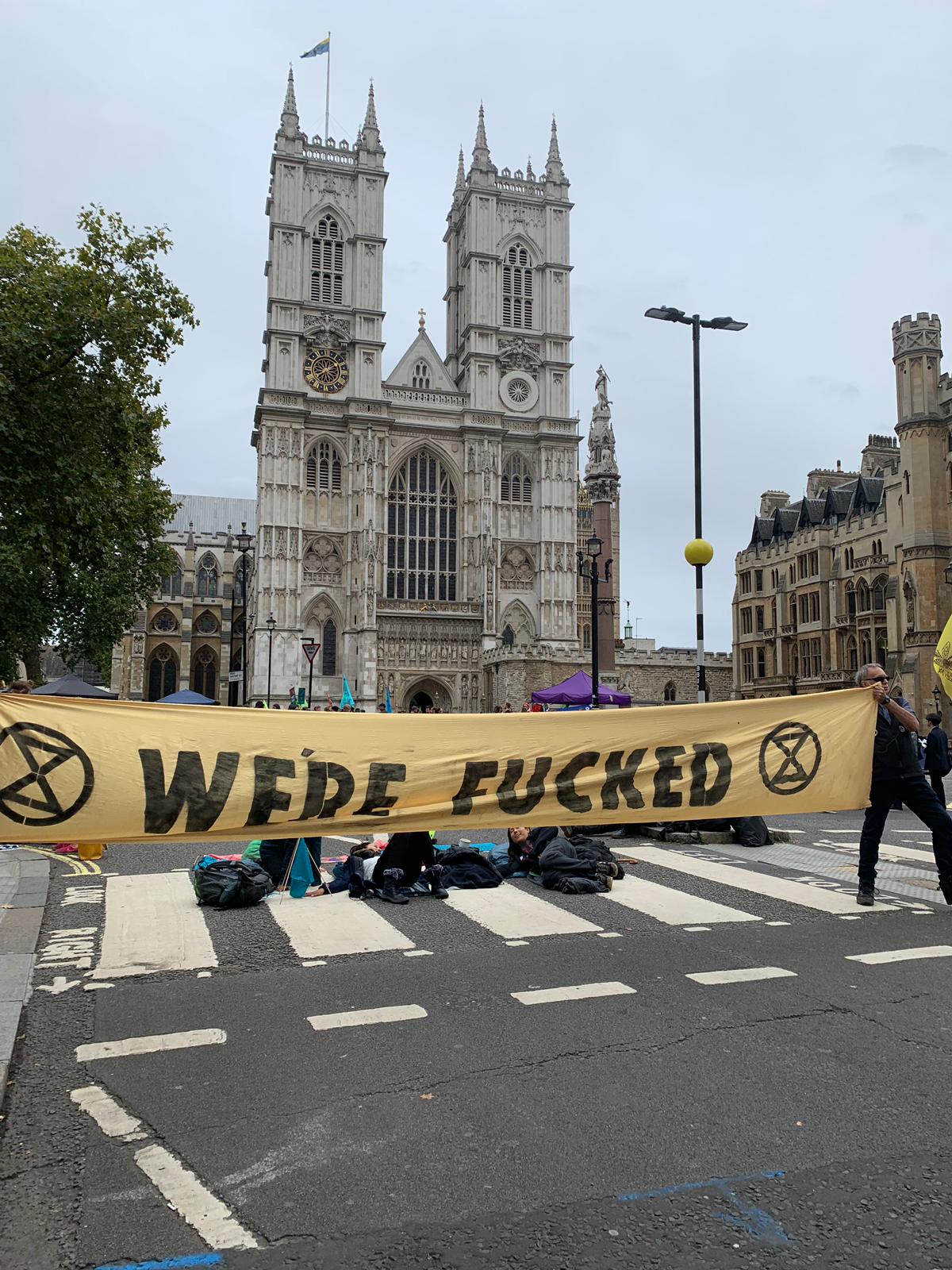 XR protest 'We're Fucked' banner in London