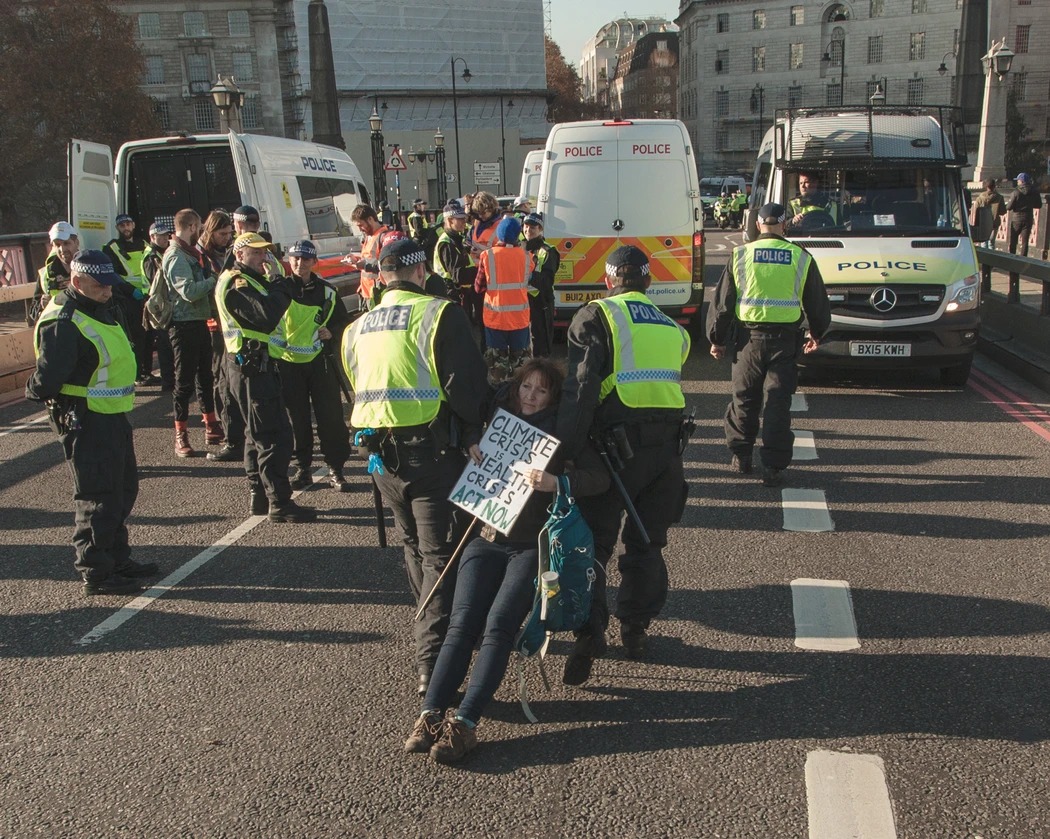 Police drag away Extinction Rebellion protester