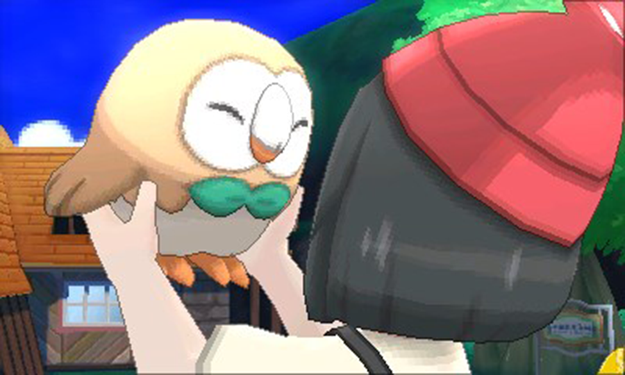 A girl with black hair wearing a red beanie lifts Rowlet, a Pokemon that looks like an owl wearing a green bowtie