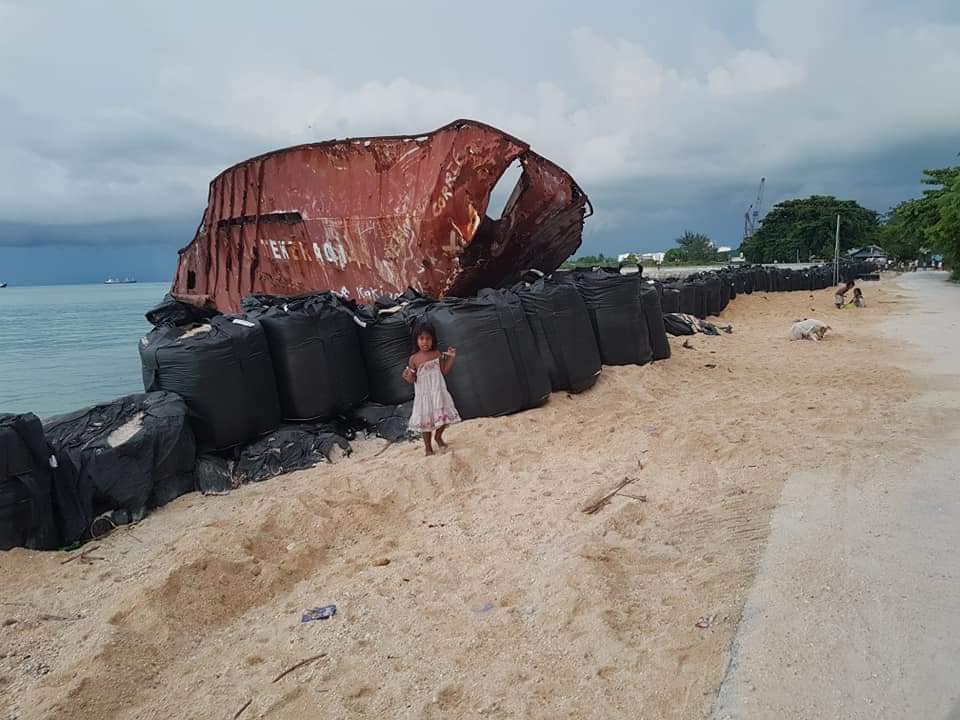 A ship that washed ashore in Tarawa during Cyclone Pam in 2015, surrounded by sandbags in August as residents prepared for the highest tide this year. Photo courtesy of Humans of Kiribati
