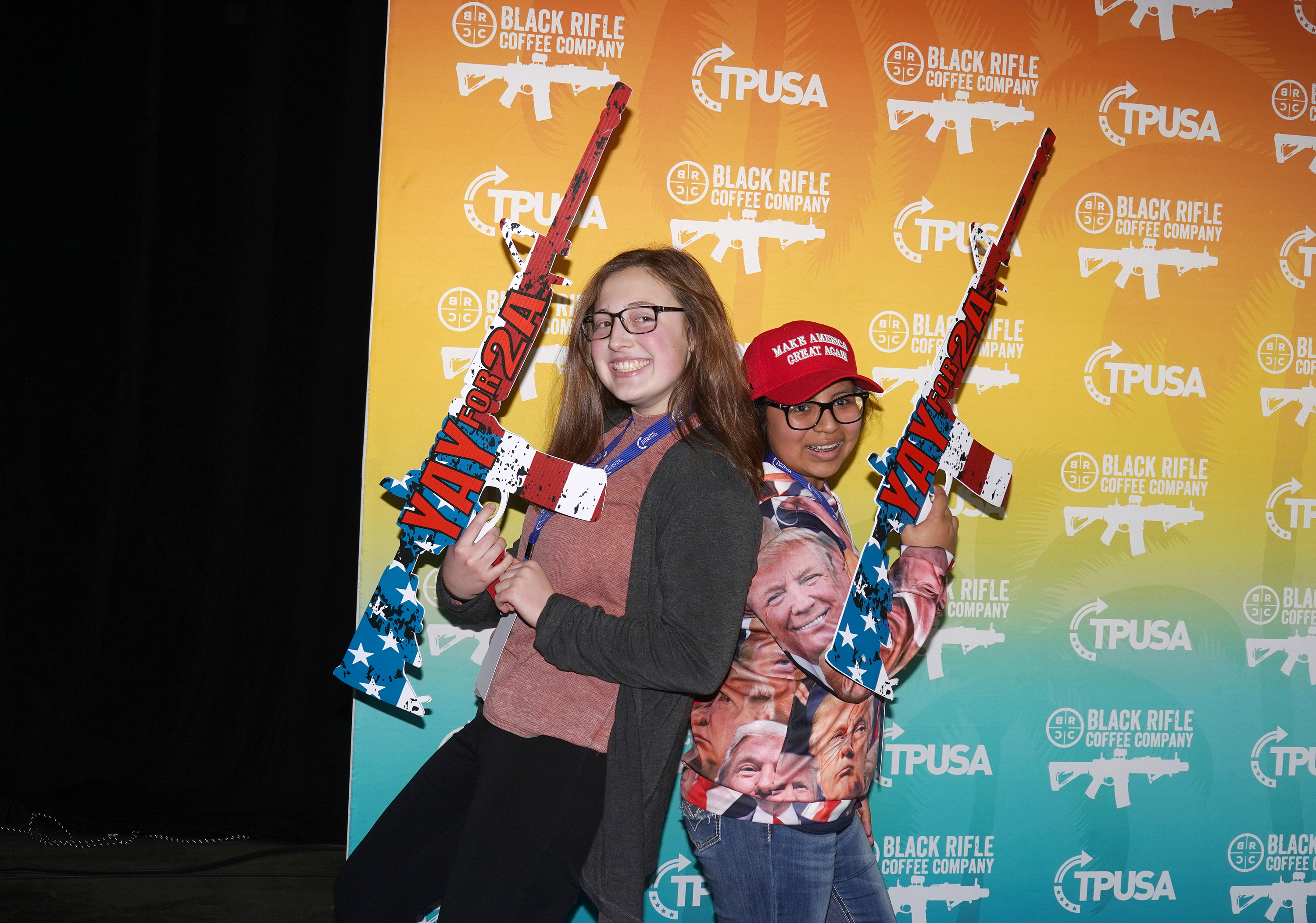 A pair of young conservatives hold patriotic fake guns.
