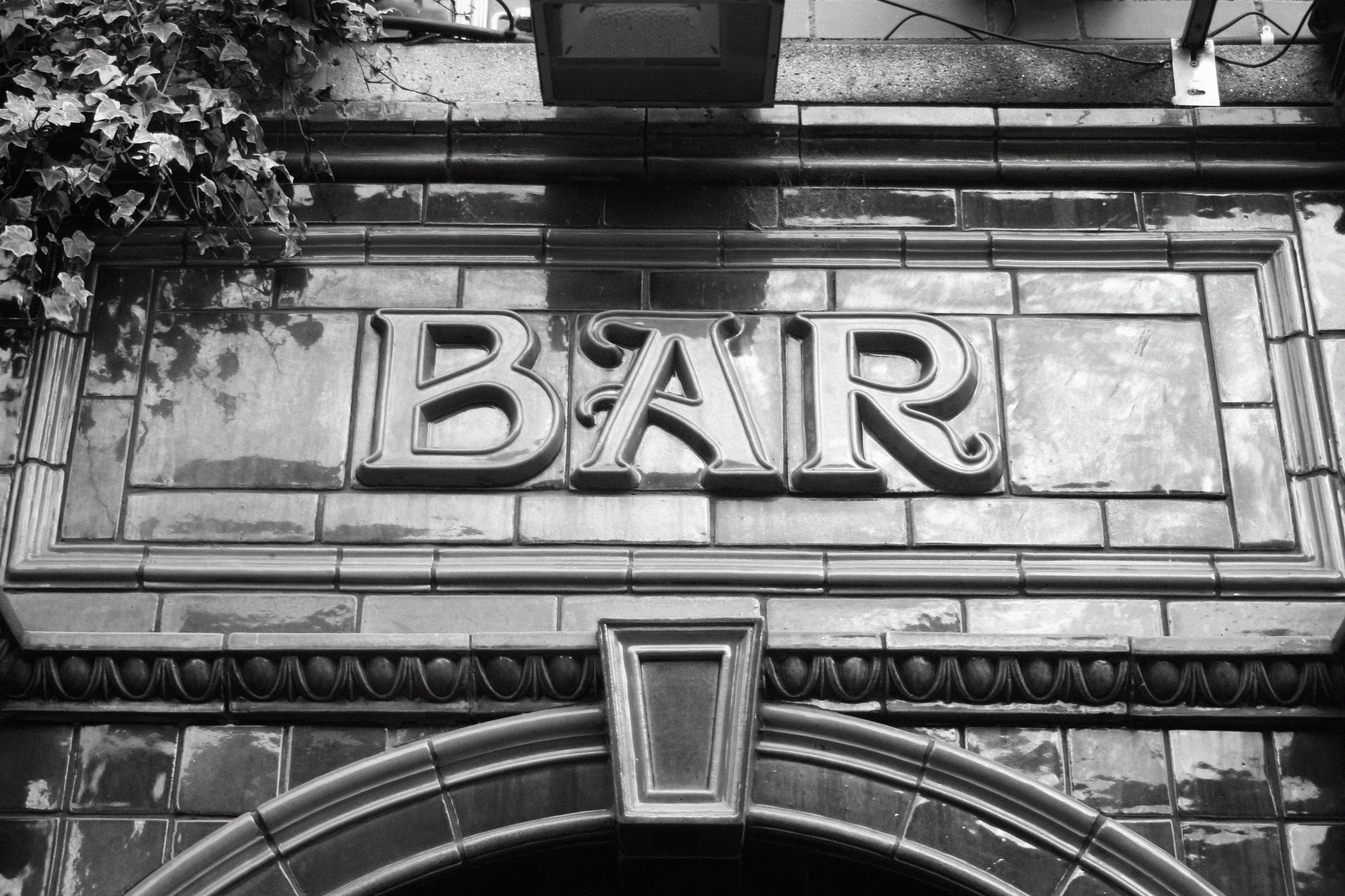 Black and white photo of stained glass bar awning 
