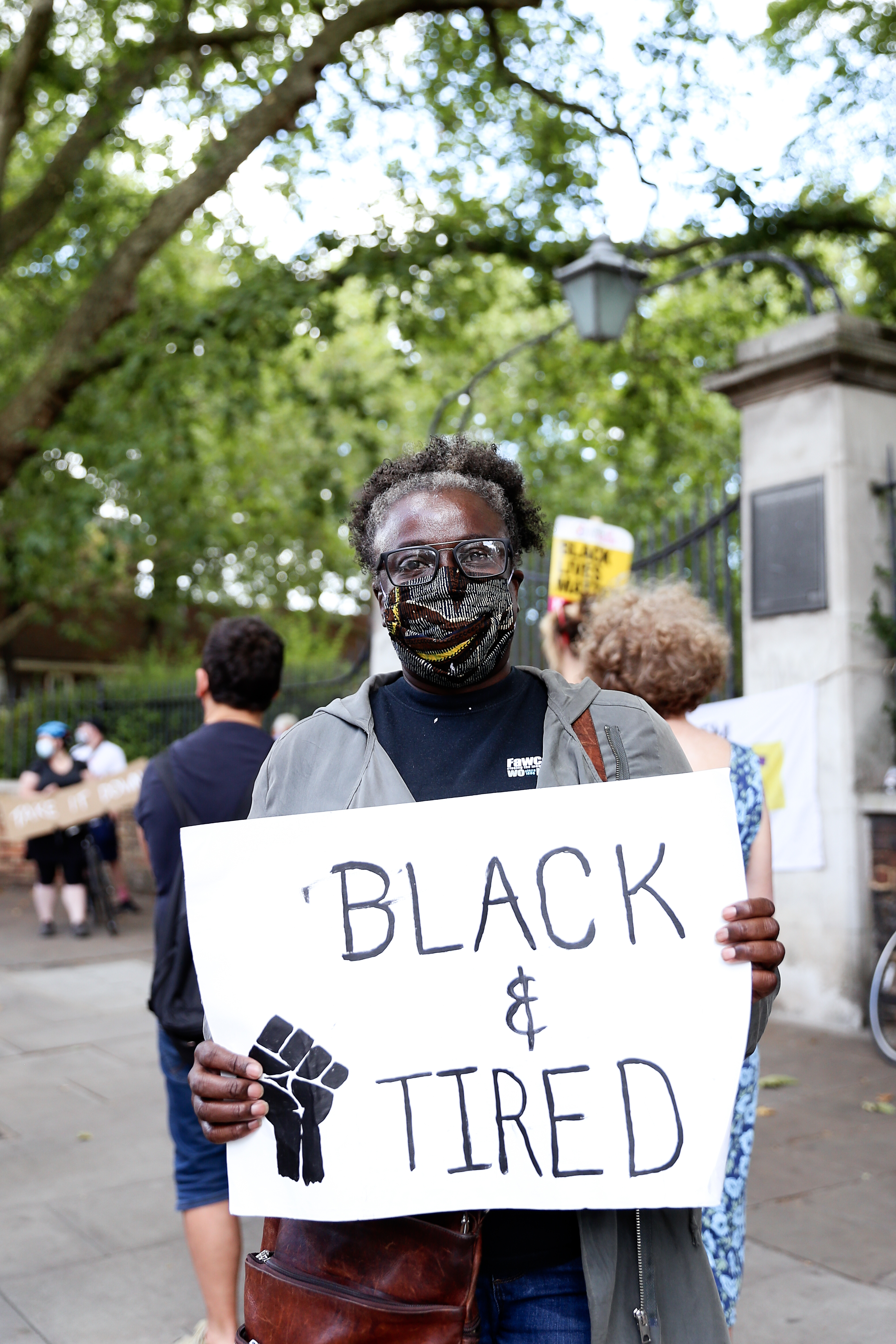 Hackney councillor Carol Williams holds up a sign saying 