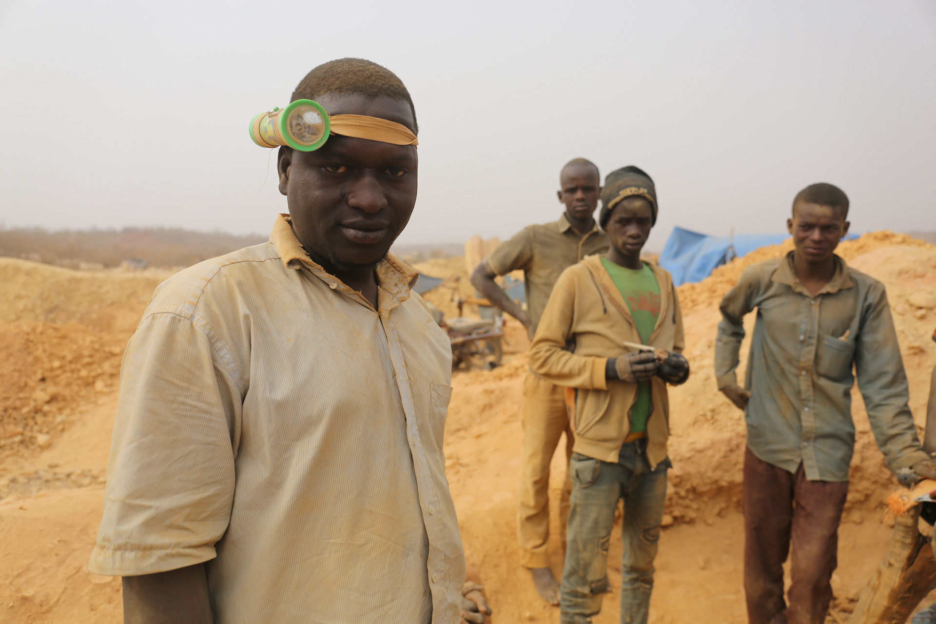 Miners prepare to descend a shaft.