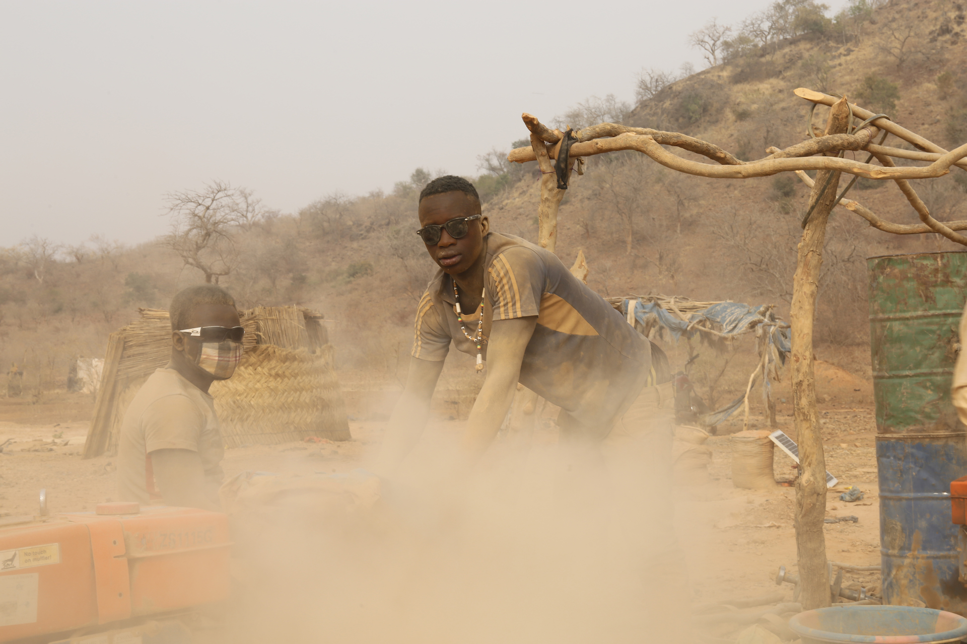 A young miner operates a rock breaking machine.