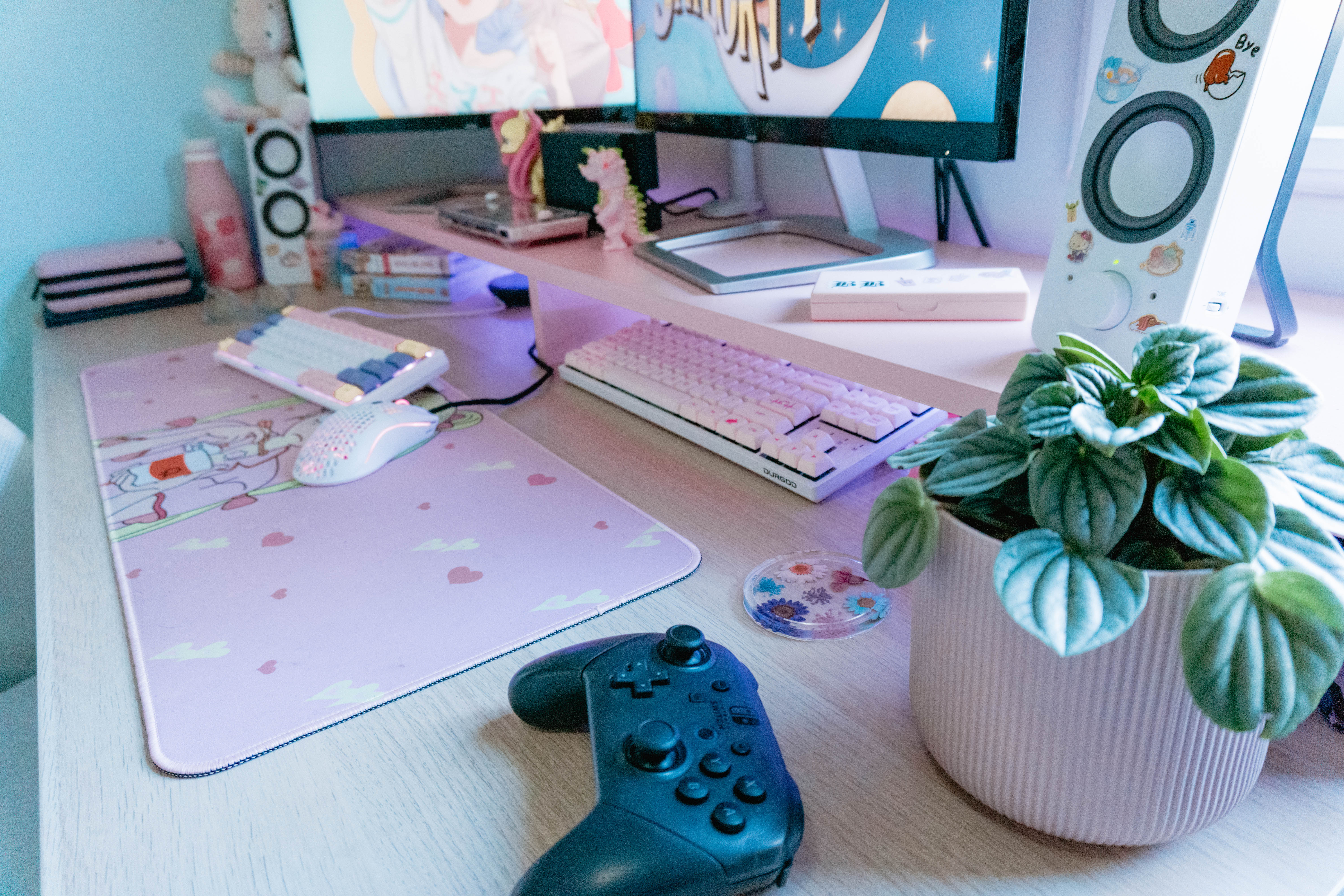 A personable, invitingly cluttered desktop with a pink floral theme for it accesories.