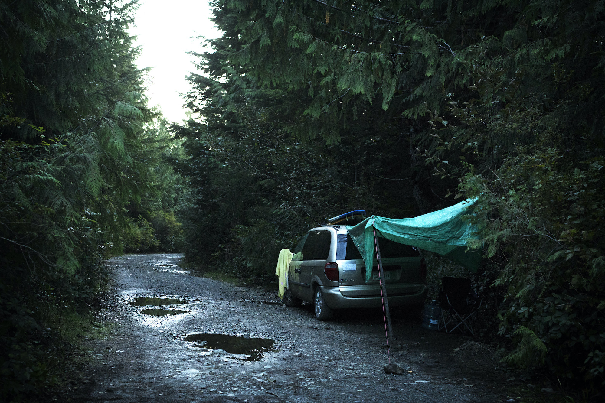 A van is stationed down one of the logging roads leading into Tofino