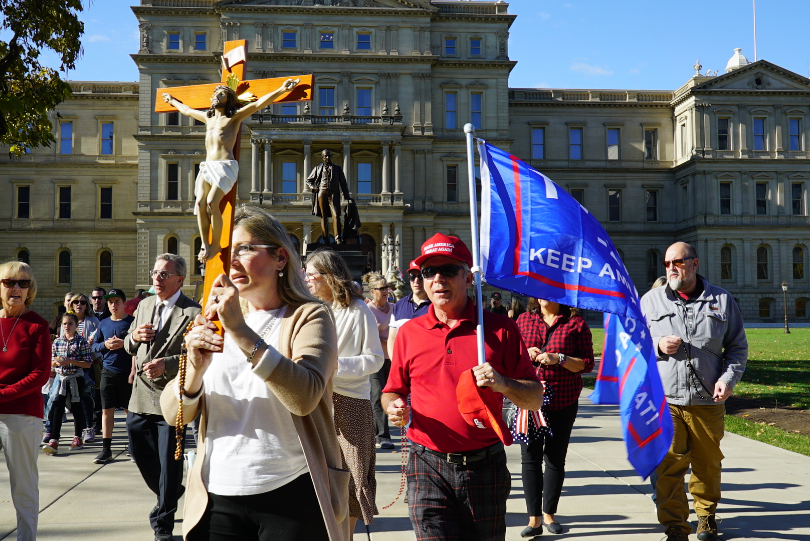 Protesters outside of the statehouse in Lansing, Michigan, holding a Trump flag and Jesus on the cross on Sunday, Nov. 8, 2020. (Jesse Seidman​​ for VICE News) 