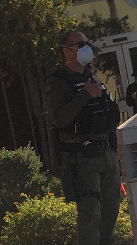 An armed police officers stands outside a polling site. Image courtesy of Arizona Native Votes