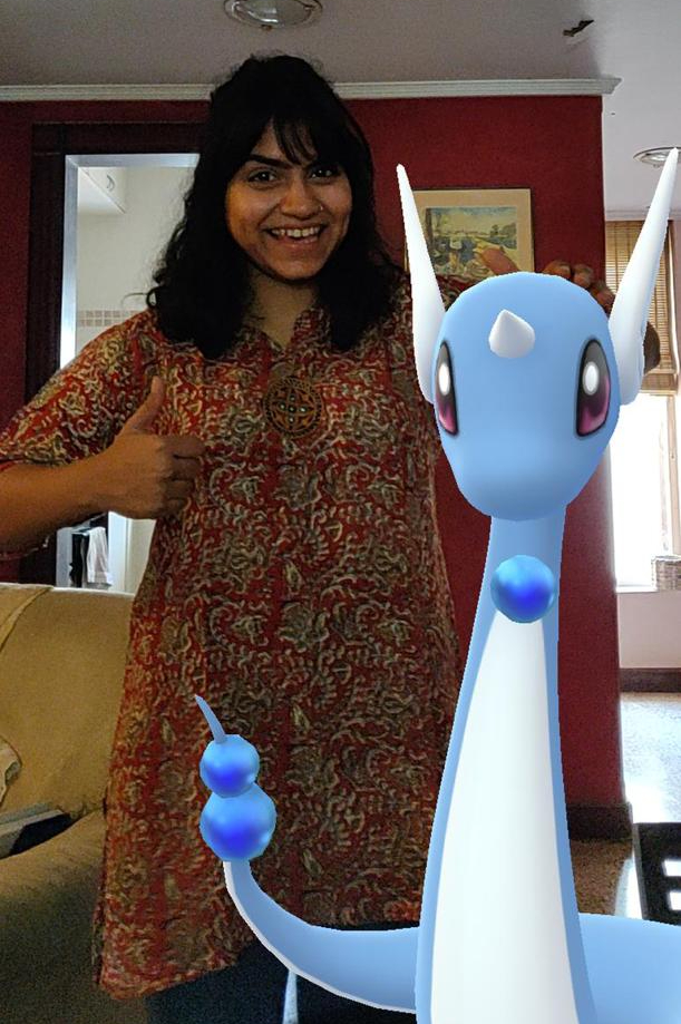 My sister with Dratini, a dragon Pokemon, at the Pokemon GO Fest