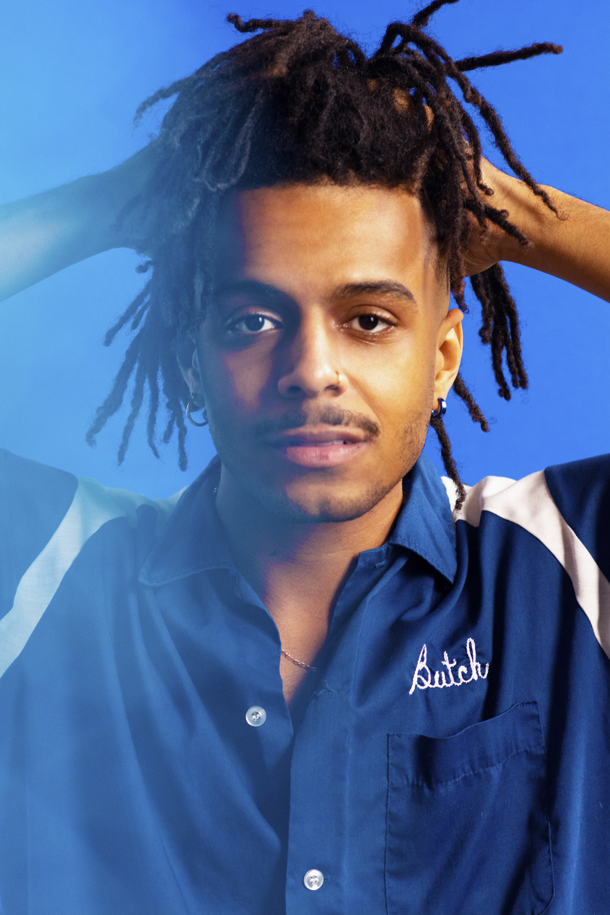 Man in blue bowling shirt. Photographed by Marcus Branch.