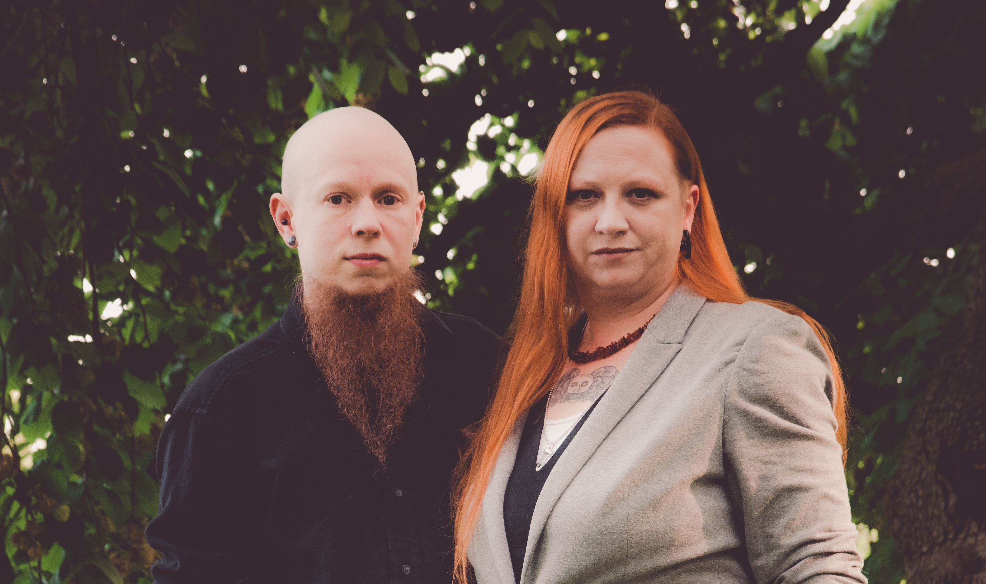 Anthony and Lee Redgrave stand in front of a background of green trees.