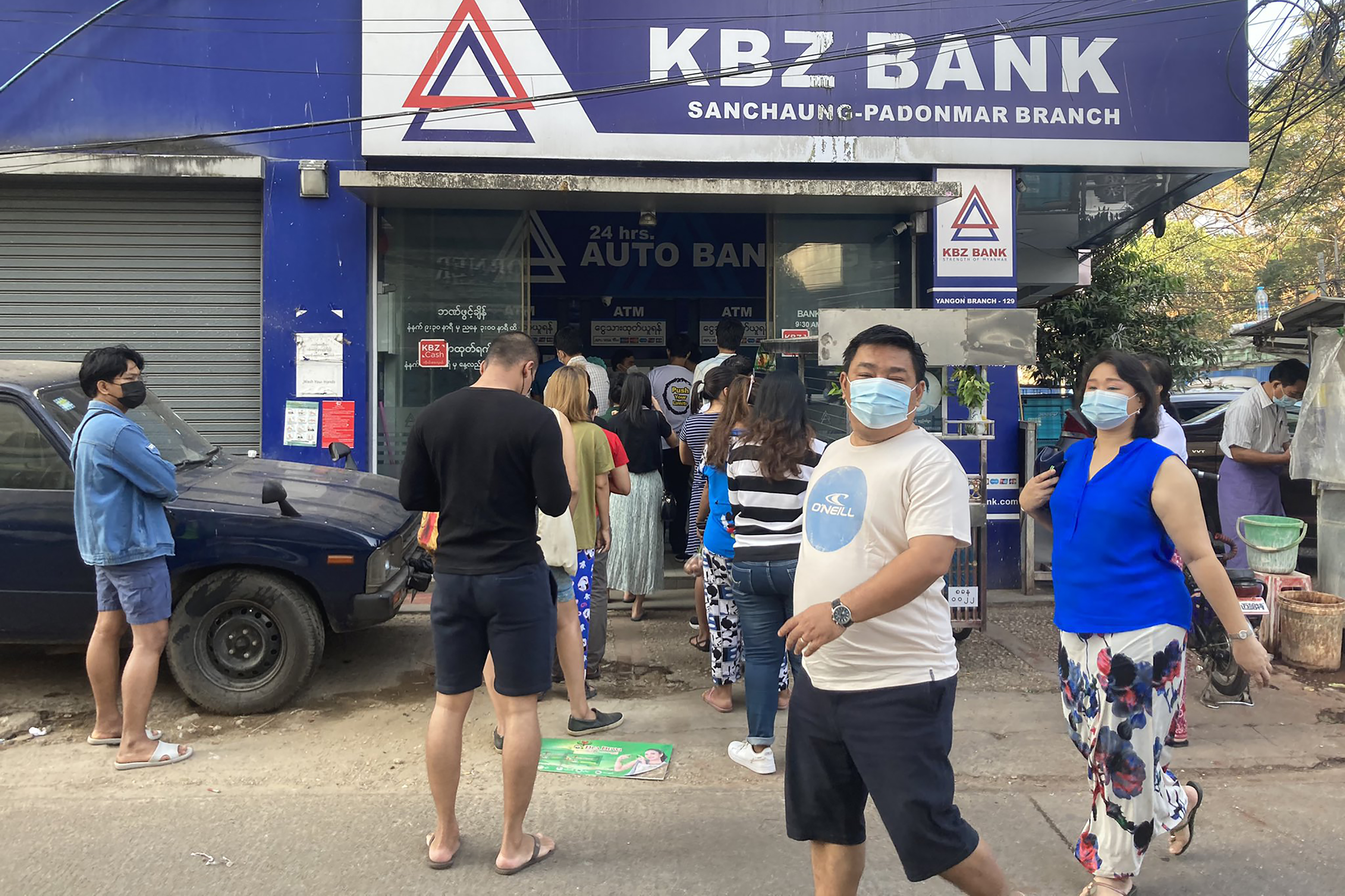 People in Yangon queue up outside a bank. PHOTO: AFP