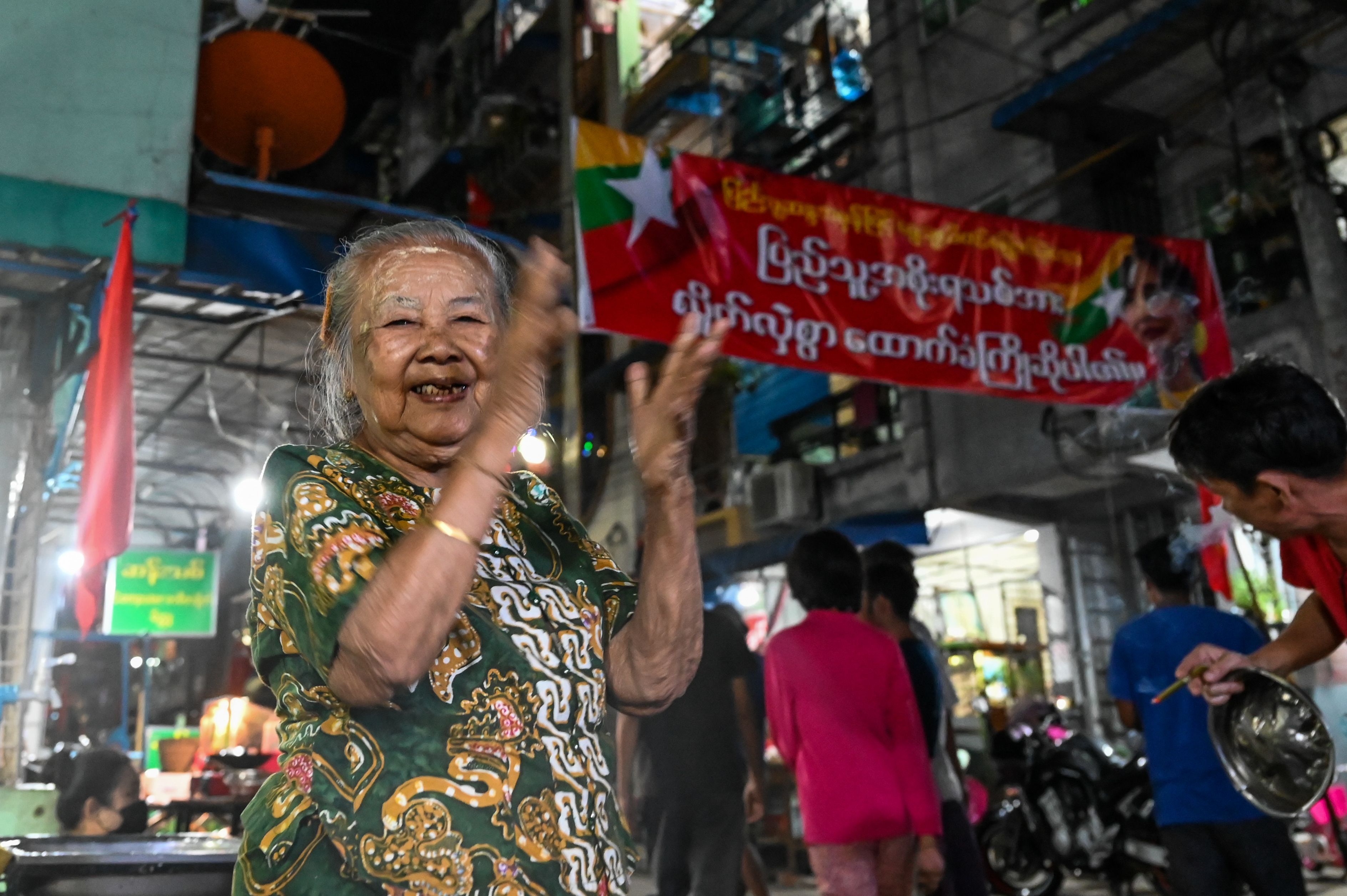 Residents take part in a noise campaign on a street in Yangon. PHOTO: AFP