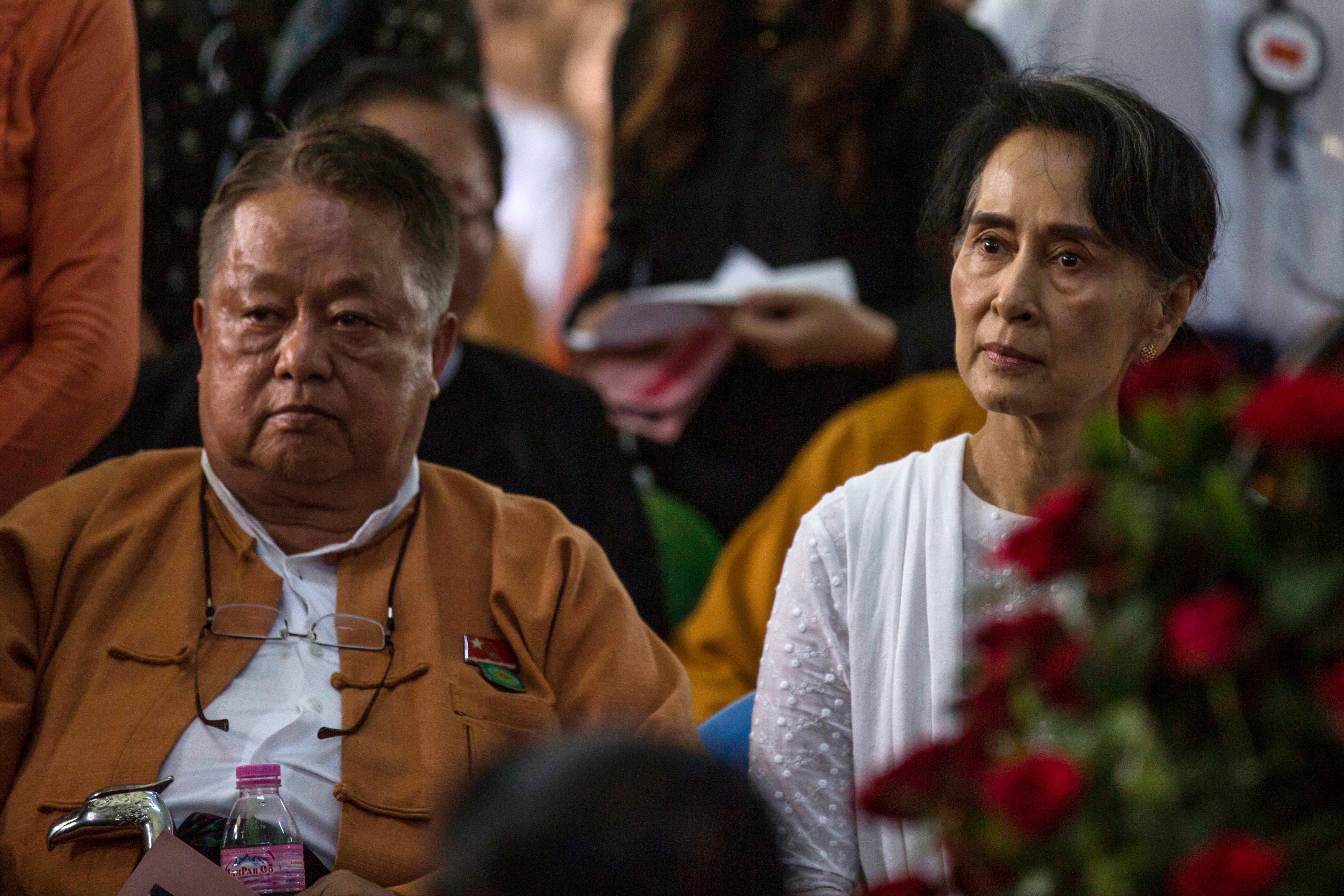 Aung San Suu Kyi and top aide Win Htein attend the funeral service of former NLD chairman Aung Shwe in Yangon. (PHOTO: AFP)