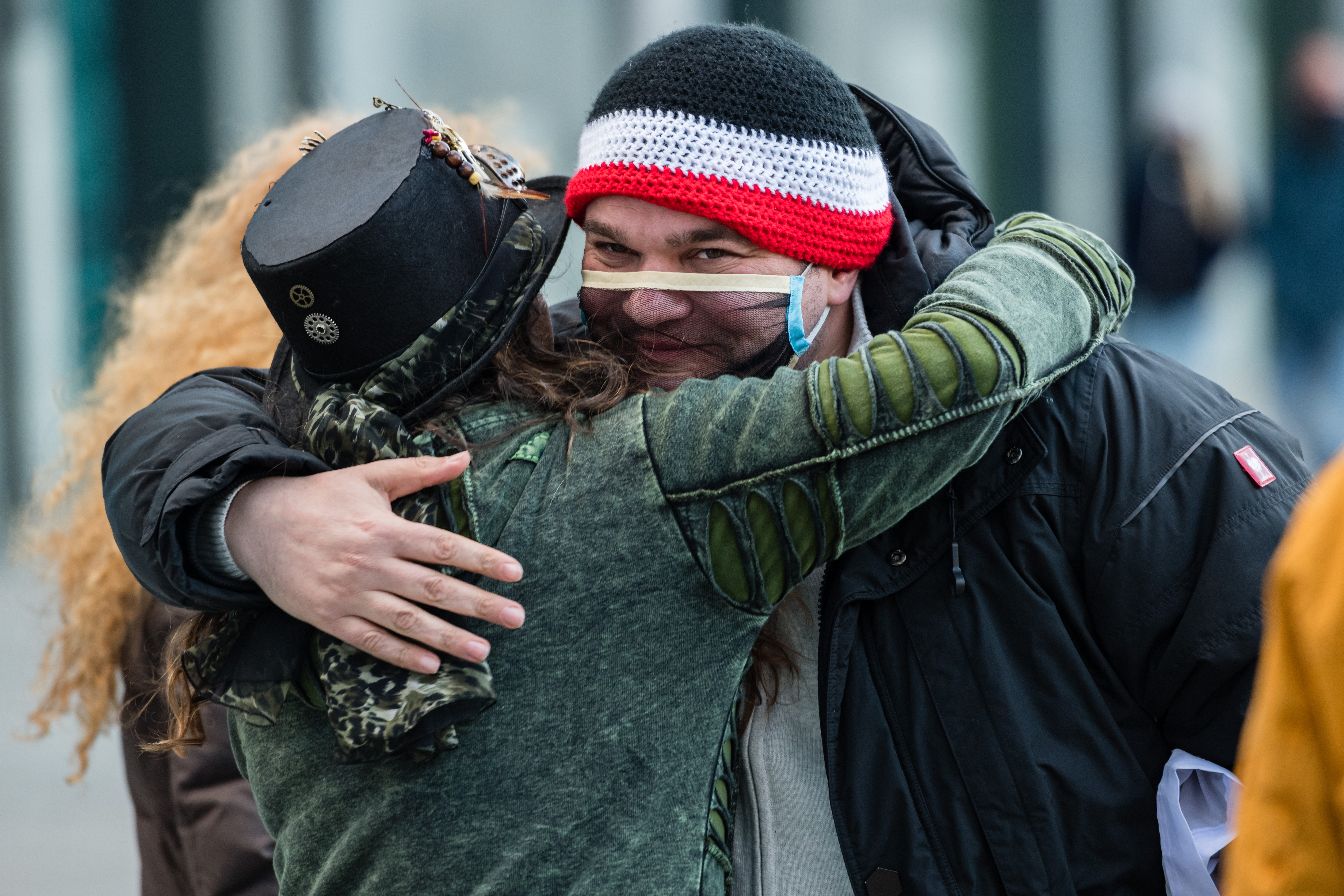 Two maskless protesters embrace in Leipzig in November last year. Photo: Stringer/Getty Images