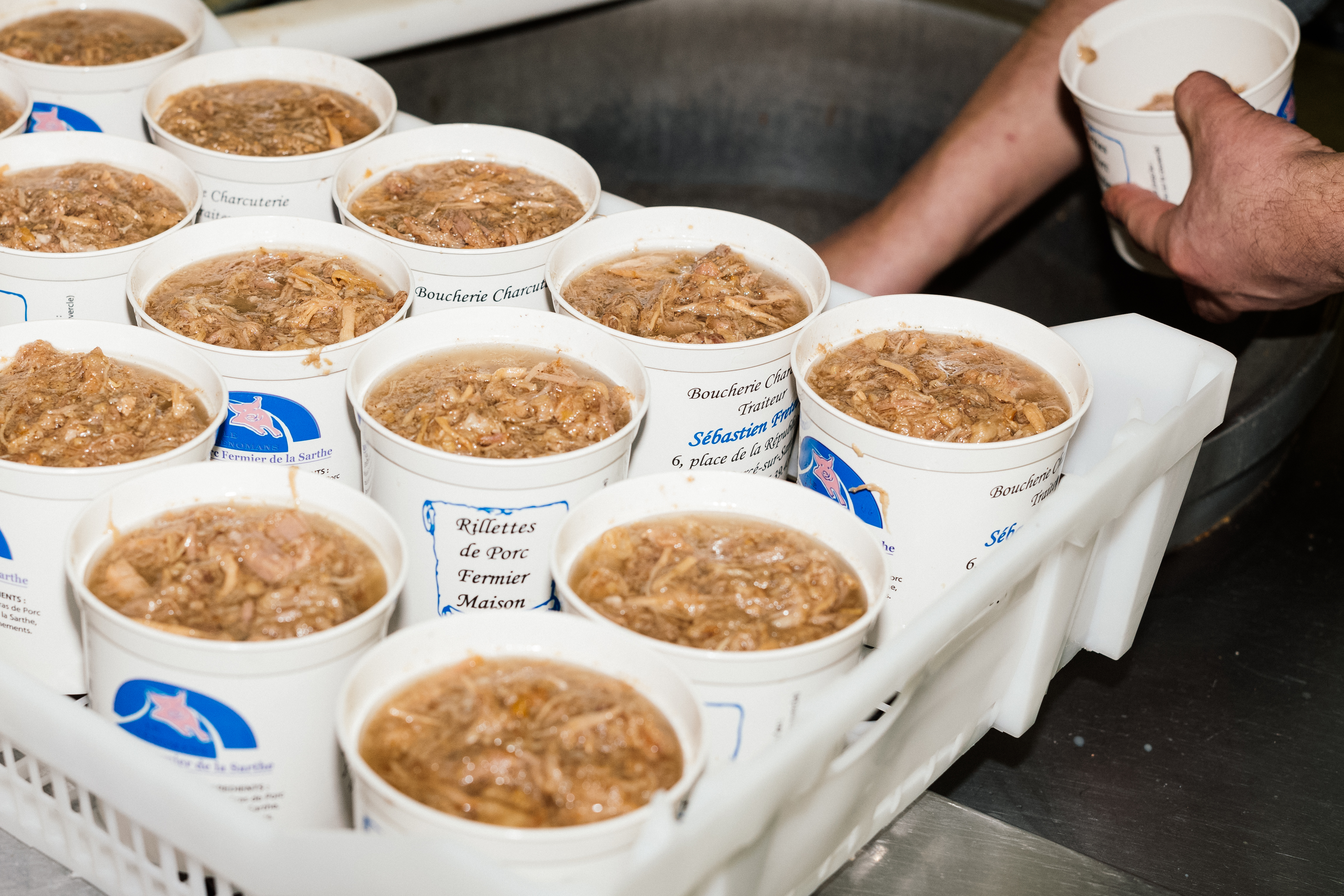 Pork rillettes – carton pint containers full of shredded meat floating in a gelatinous liquid made of fat.