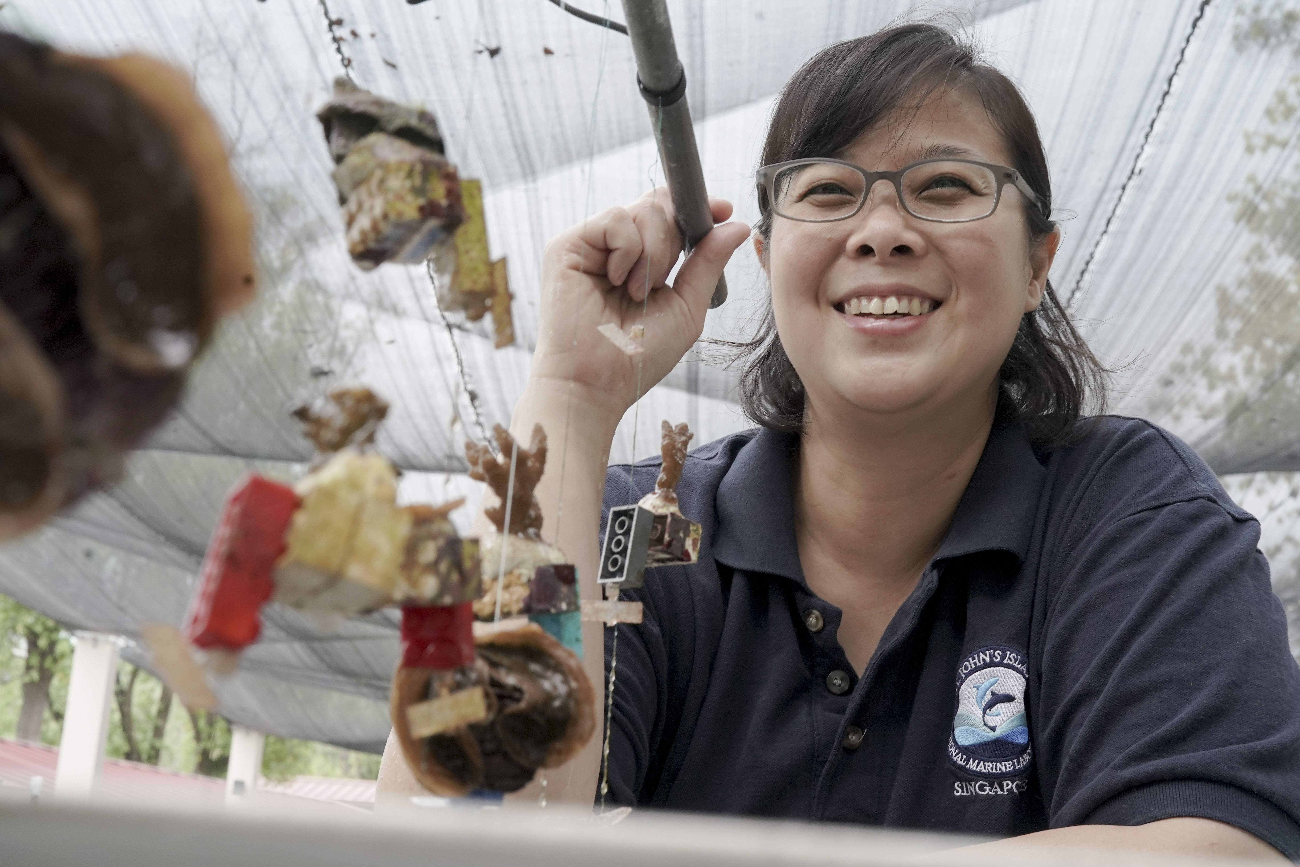 Singaporean marine biologist Jani Tanzil poses with 'Lego coral'. PHOTO: WALLACE WOON