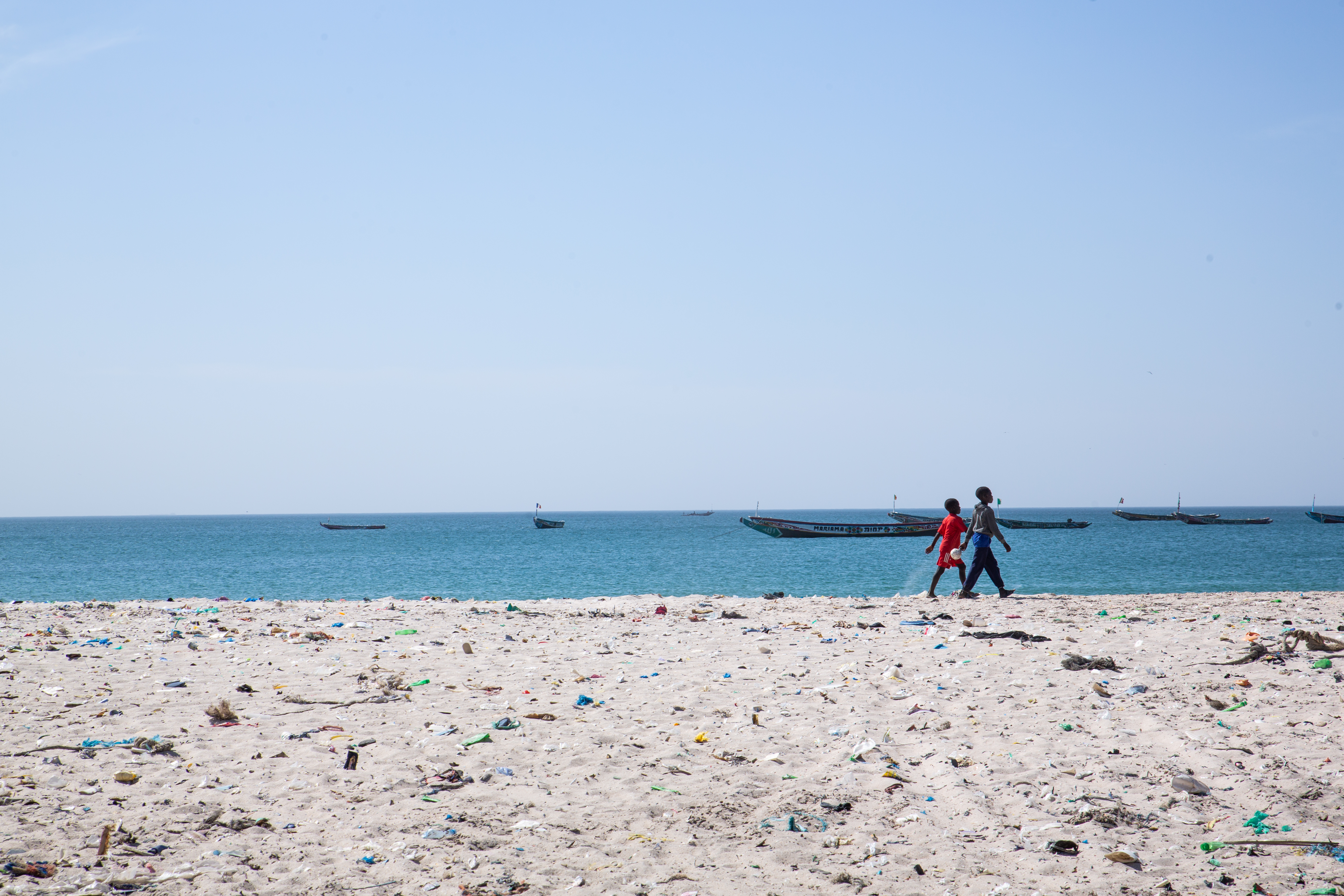 Children walk along Bargny's coast.