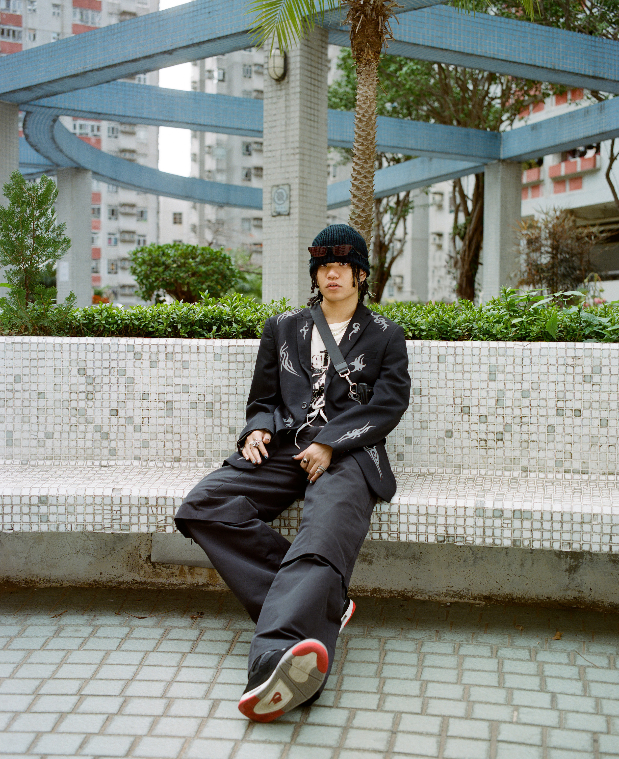 rapper-Novel-Friday-sitting-on-a-bench-in-hong-kong