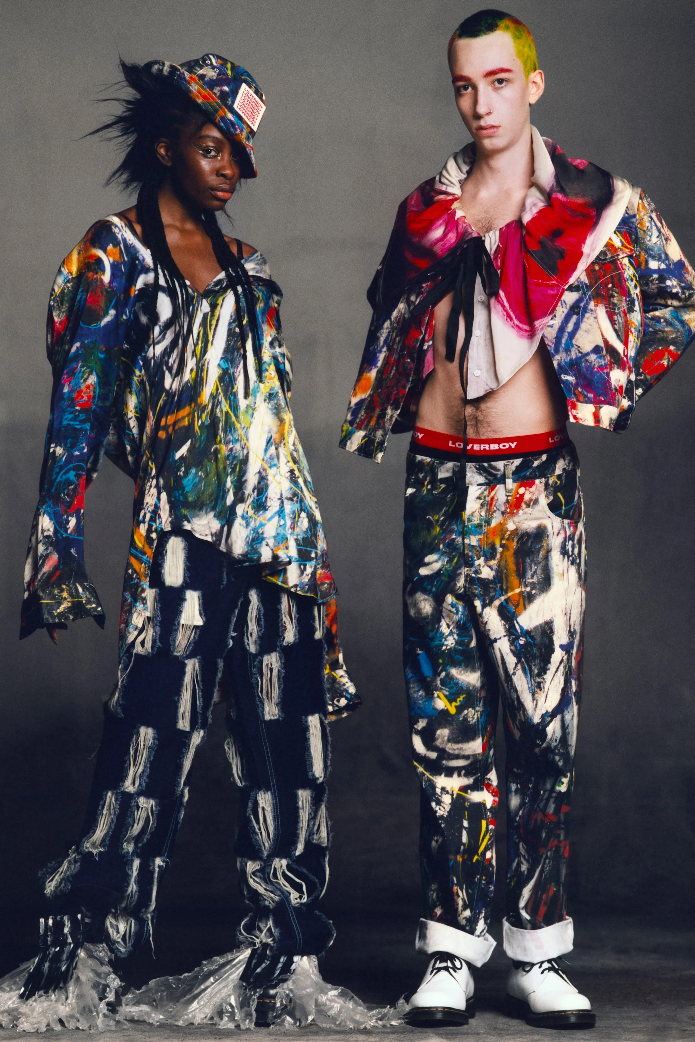Two models wearing brightly coloured clothes from Charles Jeffrey Loverboy's AW21 collection