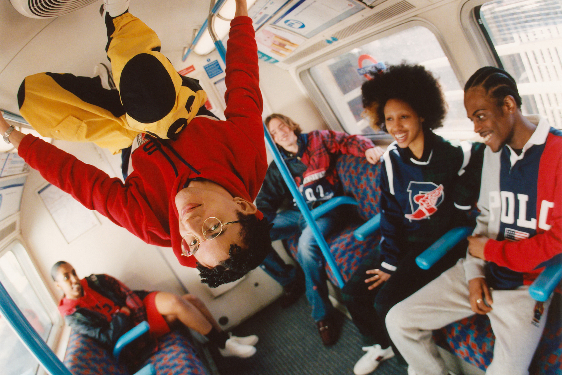 Image of a group of young models sat in a London underground carriage, wearing bright, Browns-exclusive Polo Ralph Lauren garments