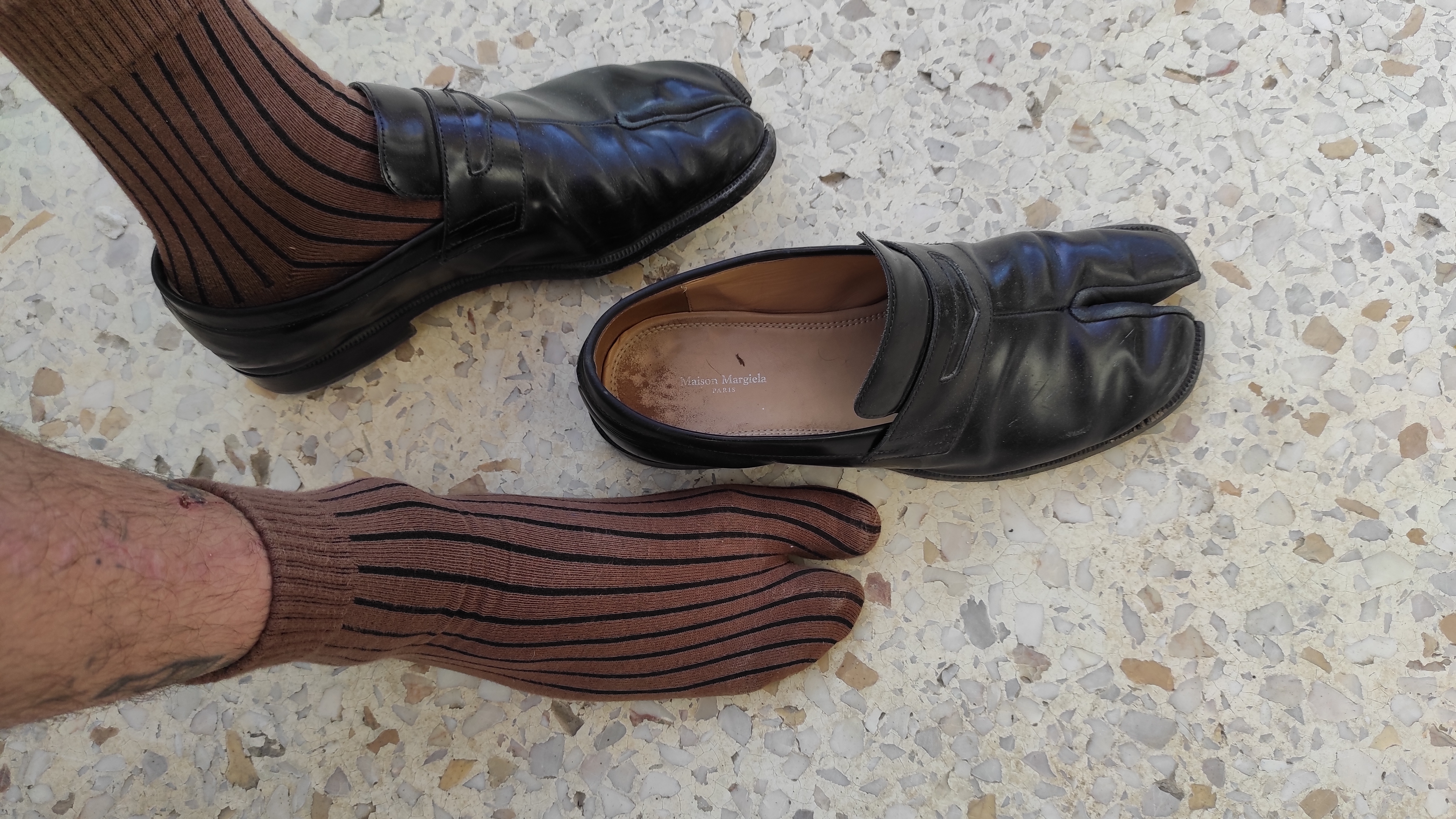 a pair of tabi shoes and a foot wearing tabi socks