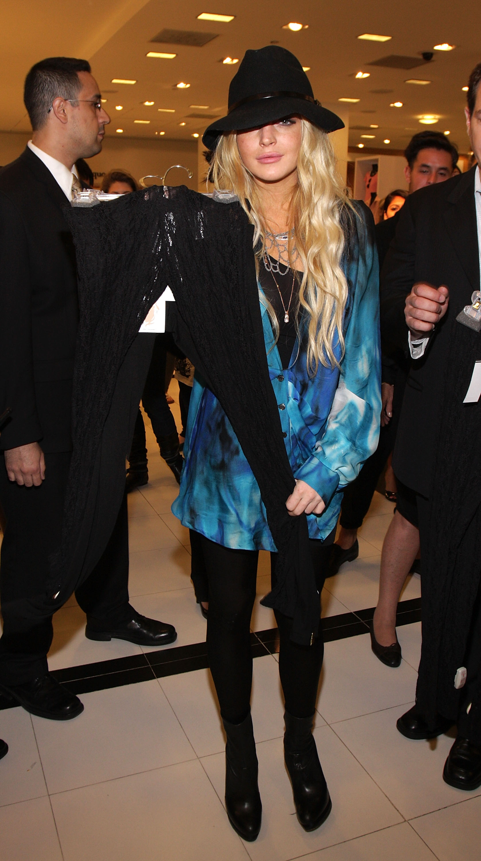 lindsay lohan holding up lace leggings she designed at bloomingdales