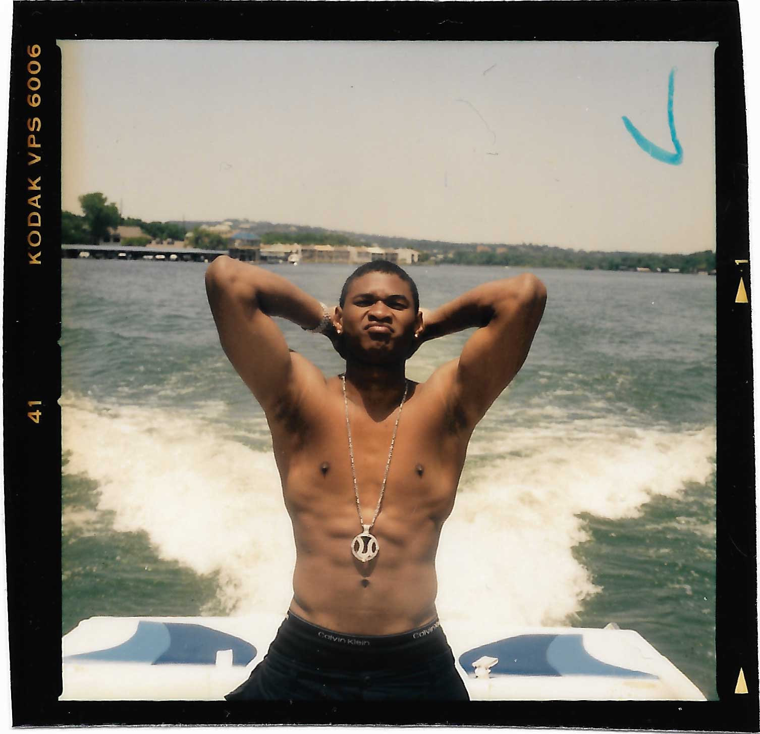 USHER posing on the back of a boat in the 90s photographed by jamil gs