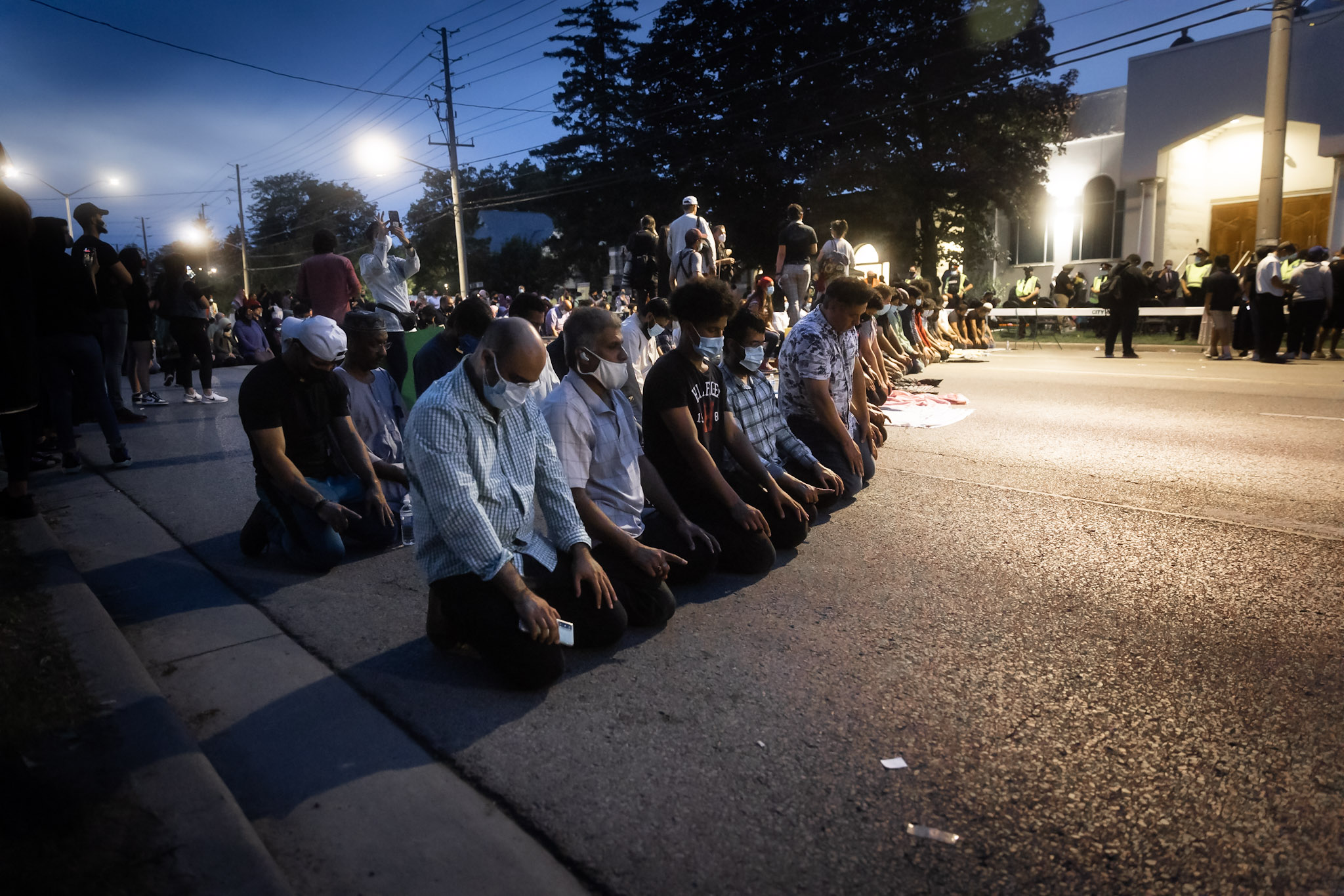 Community members pray outside the London Muslim Mosque.
