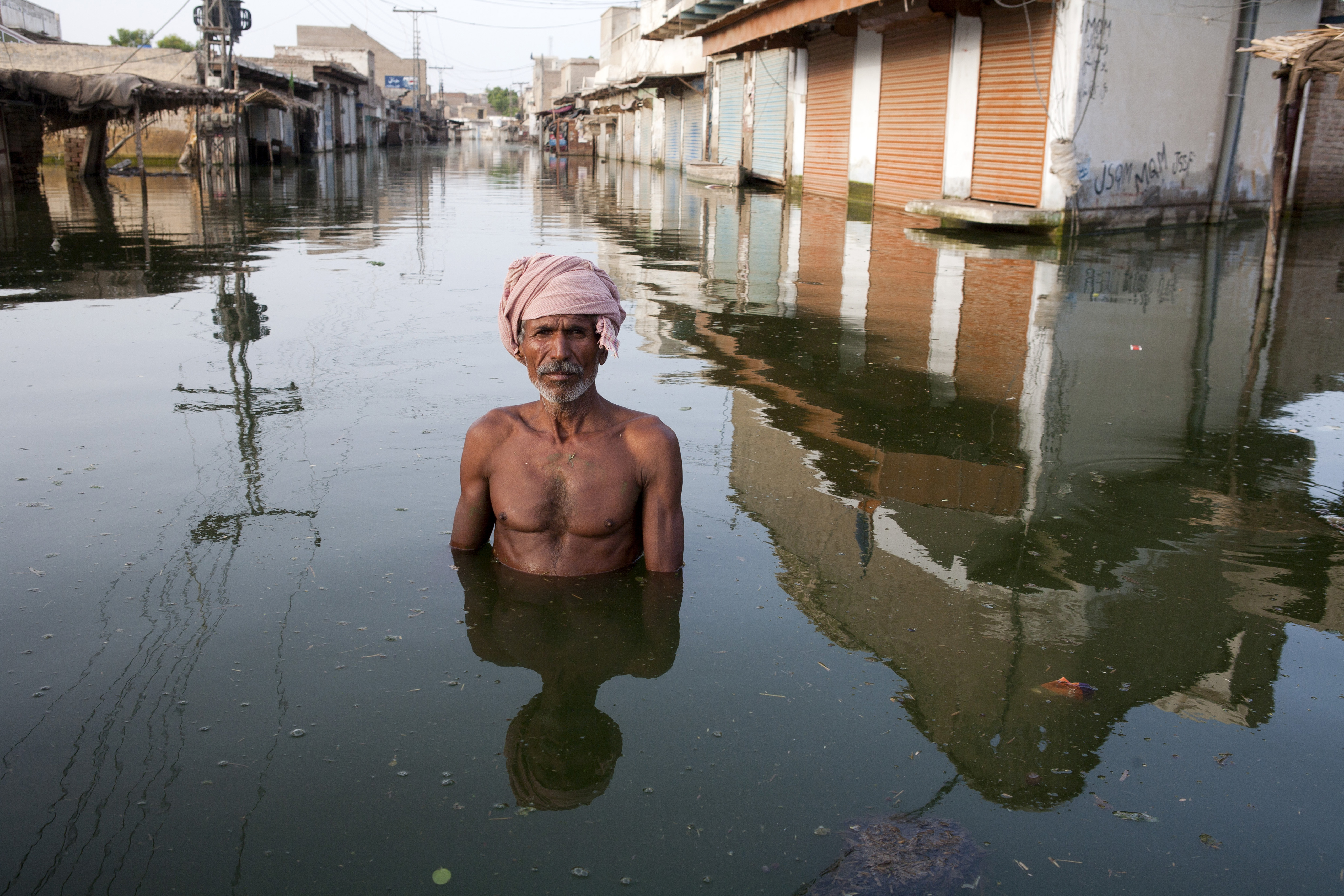 A man named Ahmed stands in the flooded town of Khairpur Nathan Shah in Pakistan in 2010. Photo: Gideon Mendel For Action Aid/ In Pictures/Corbis via Getty Images