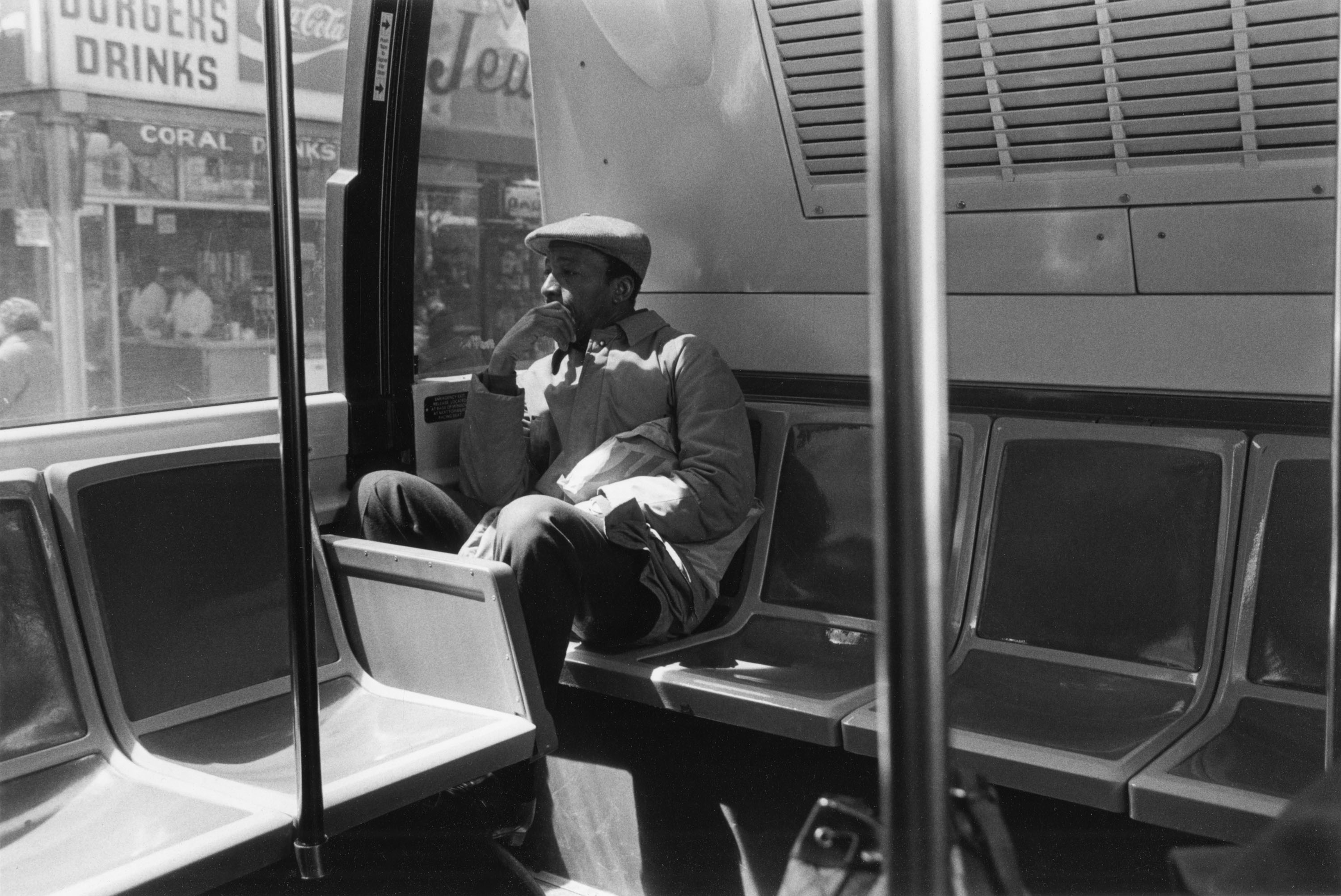 a man sitting on the backseat of a bus, looking out the window7_Bey_Man_Bus_1986.jpg