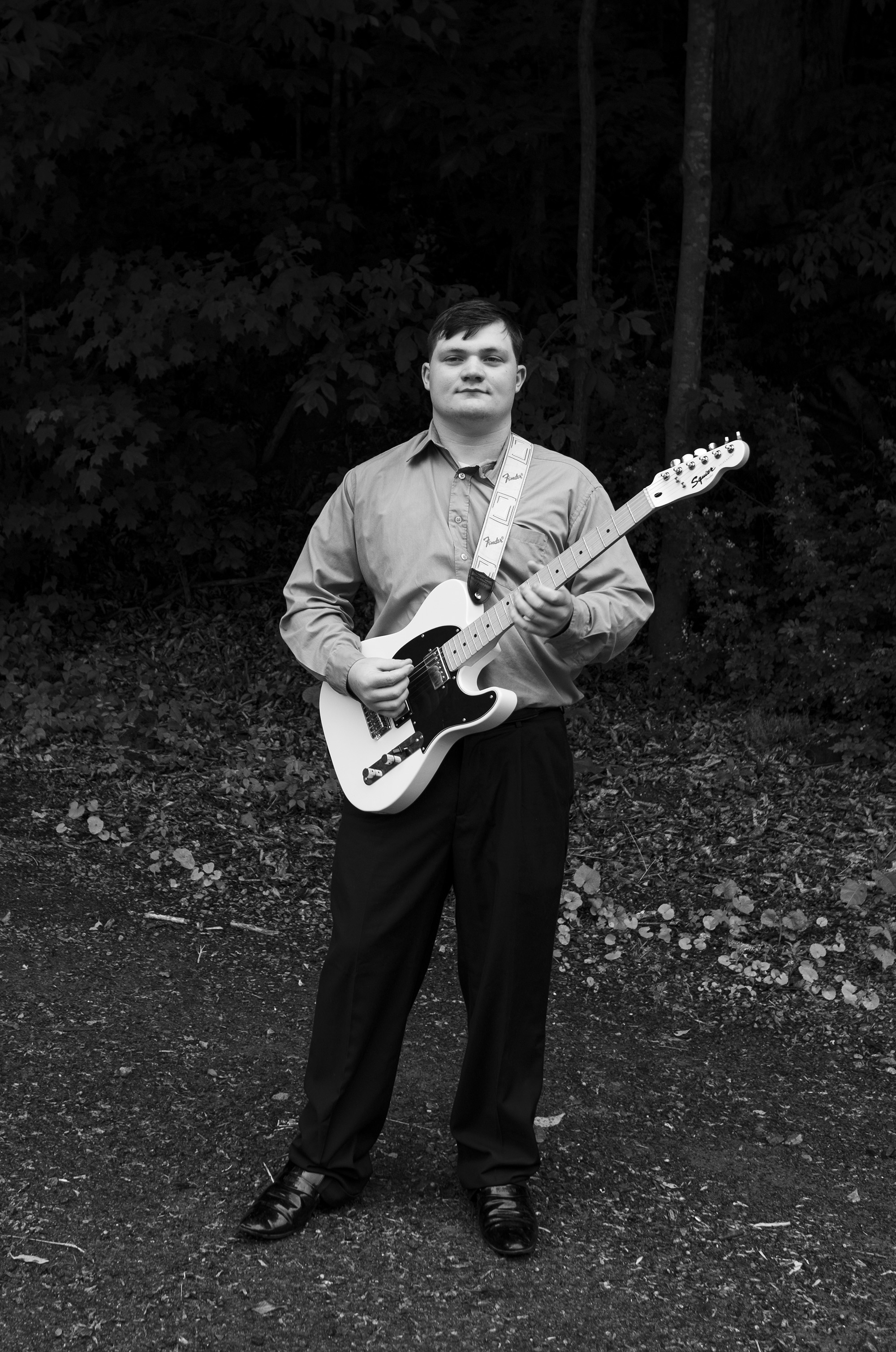 a young man playing a guitar