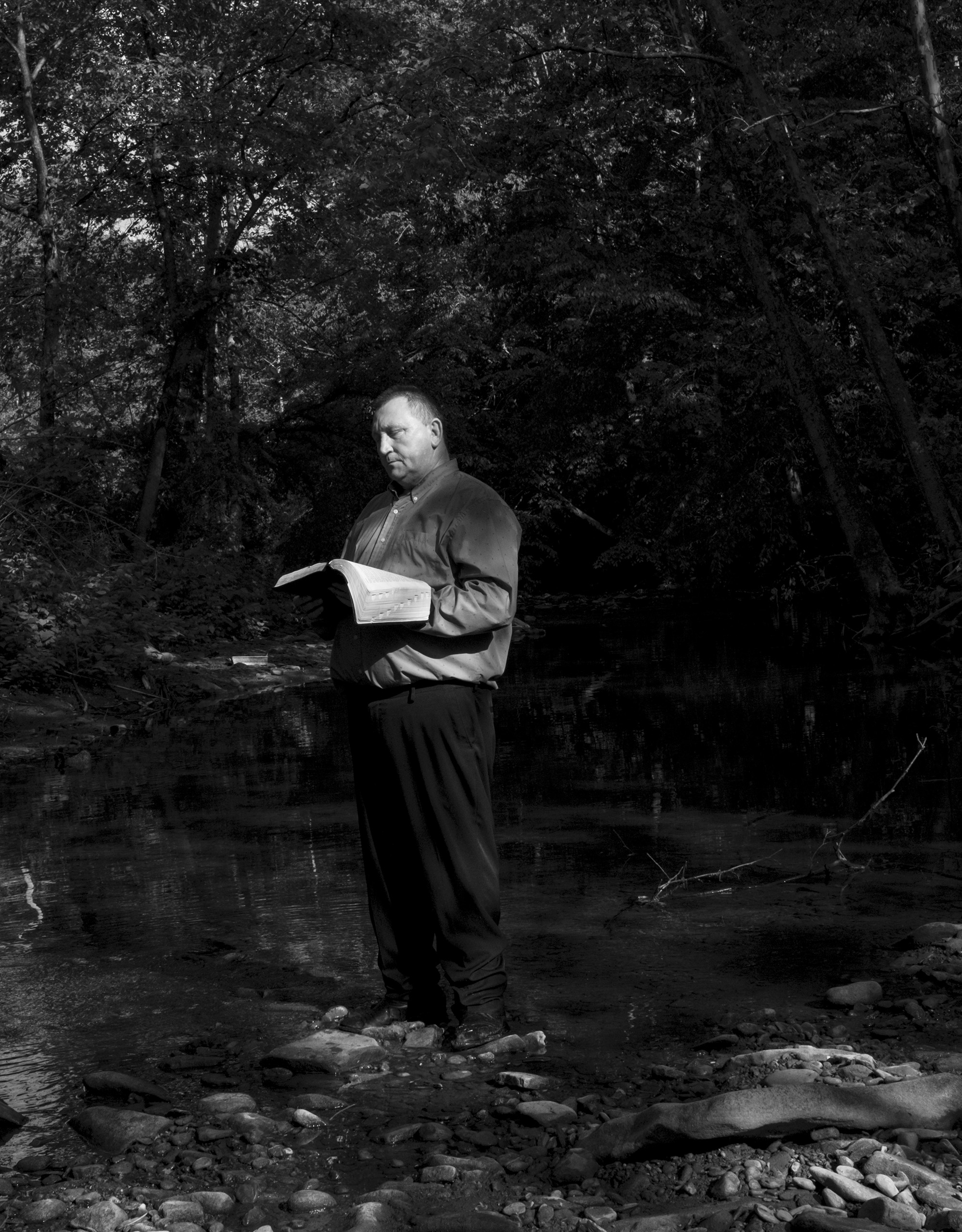 a pastor holding a bible and reading