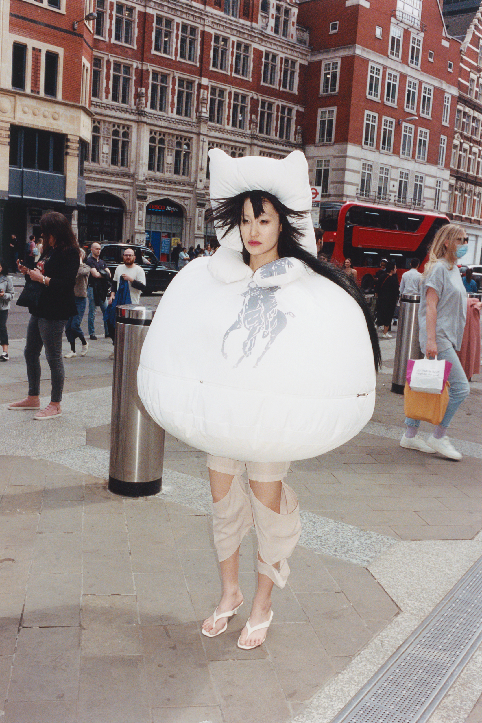 a woman walking through london wearing an inflatable dress by Fey Fey