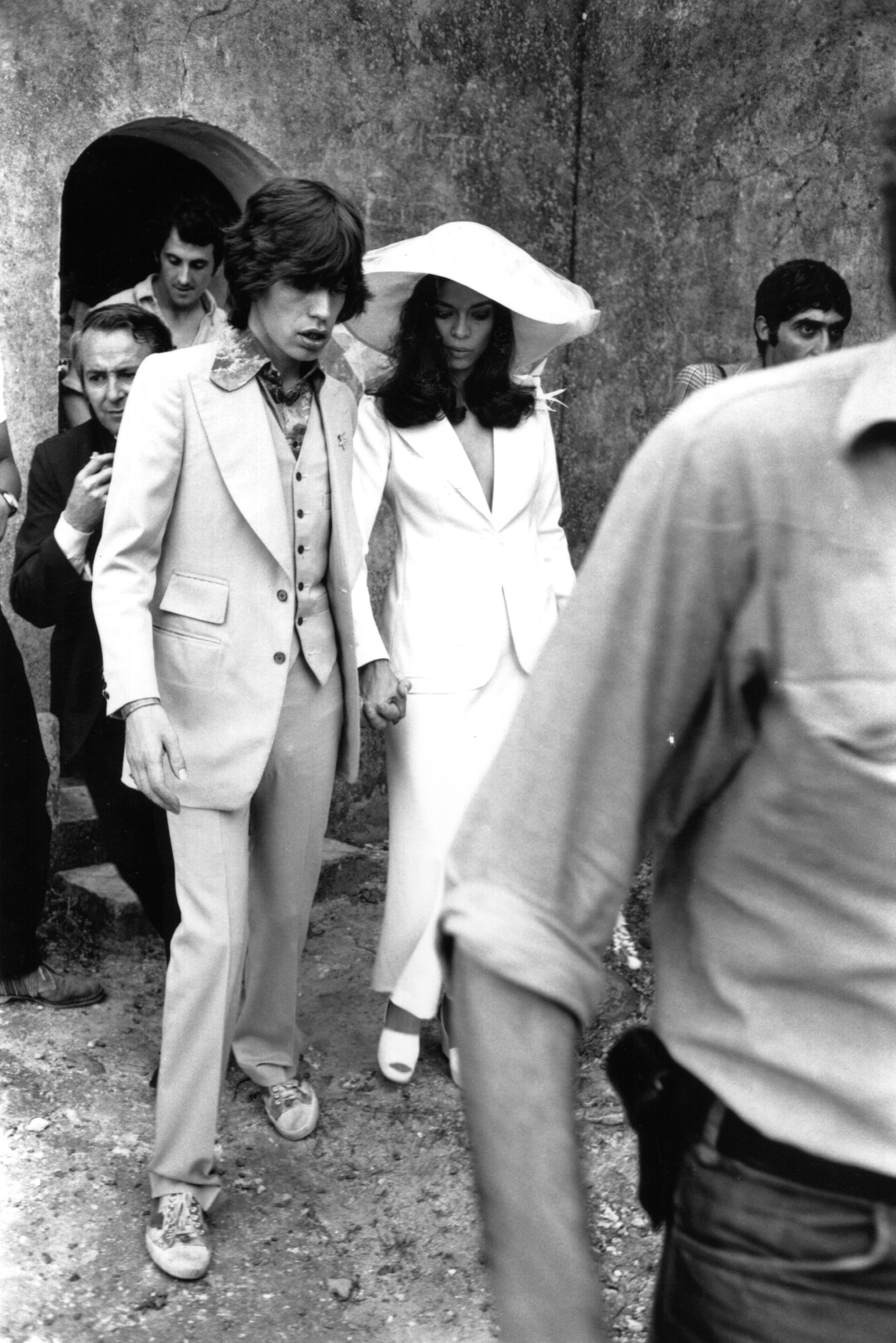 mick jagger and bianca jagger holding hands at their wedding in st. tropez