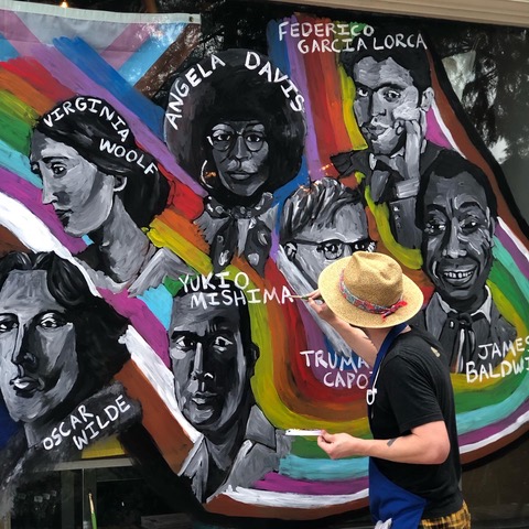 A Pride mural of LGBTQ+ authors featured in Beausoleil storefront window painted by local artist Benjamin Koch 