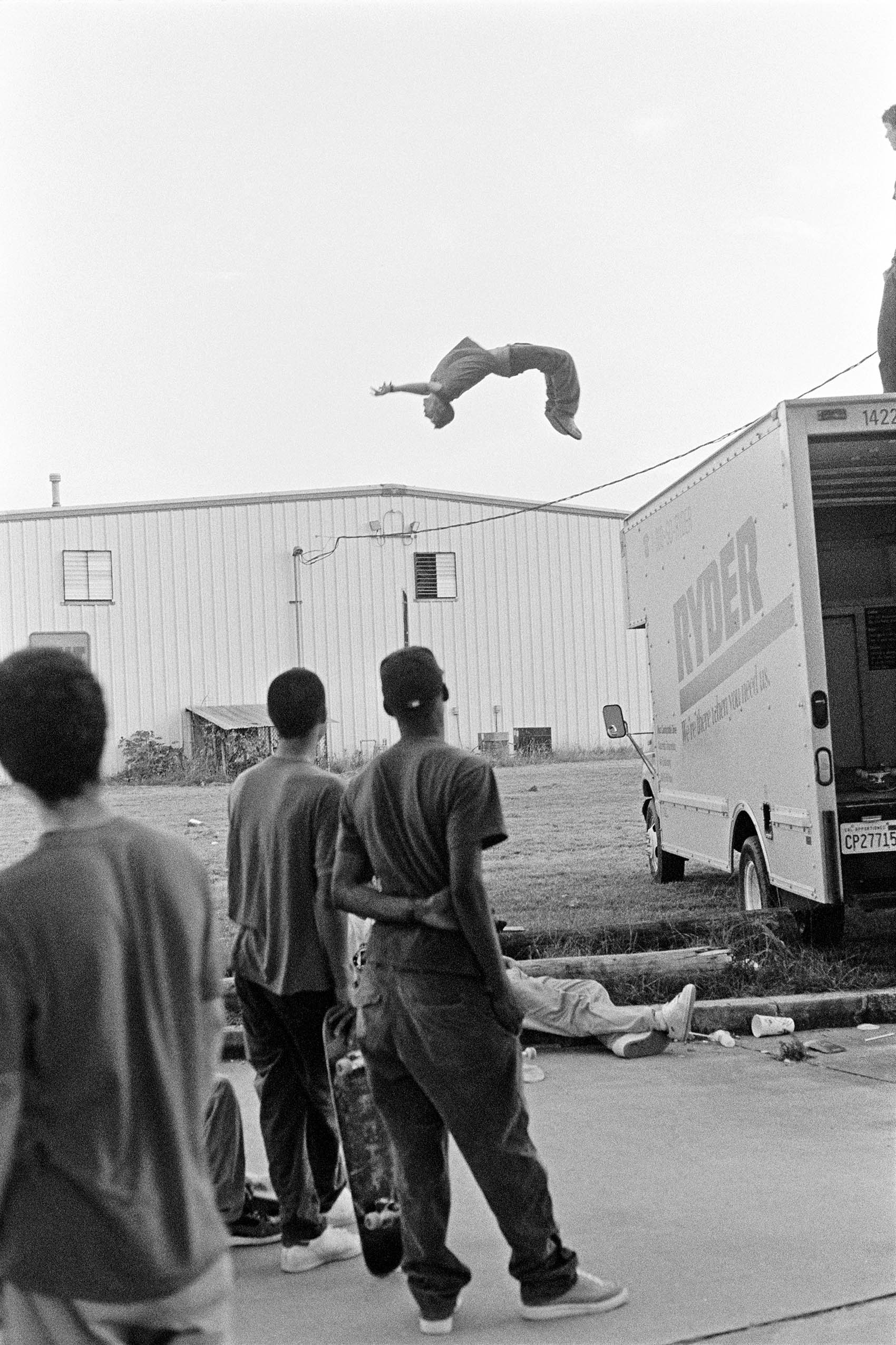 a man backflipping off the back of a van