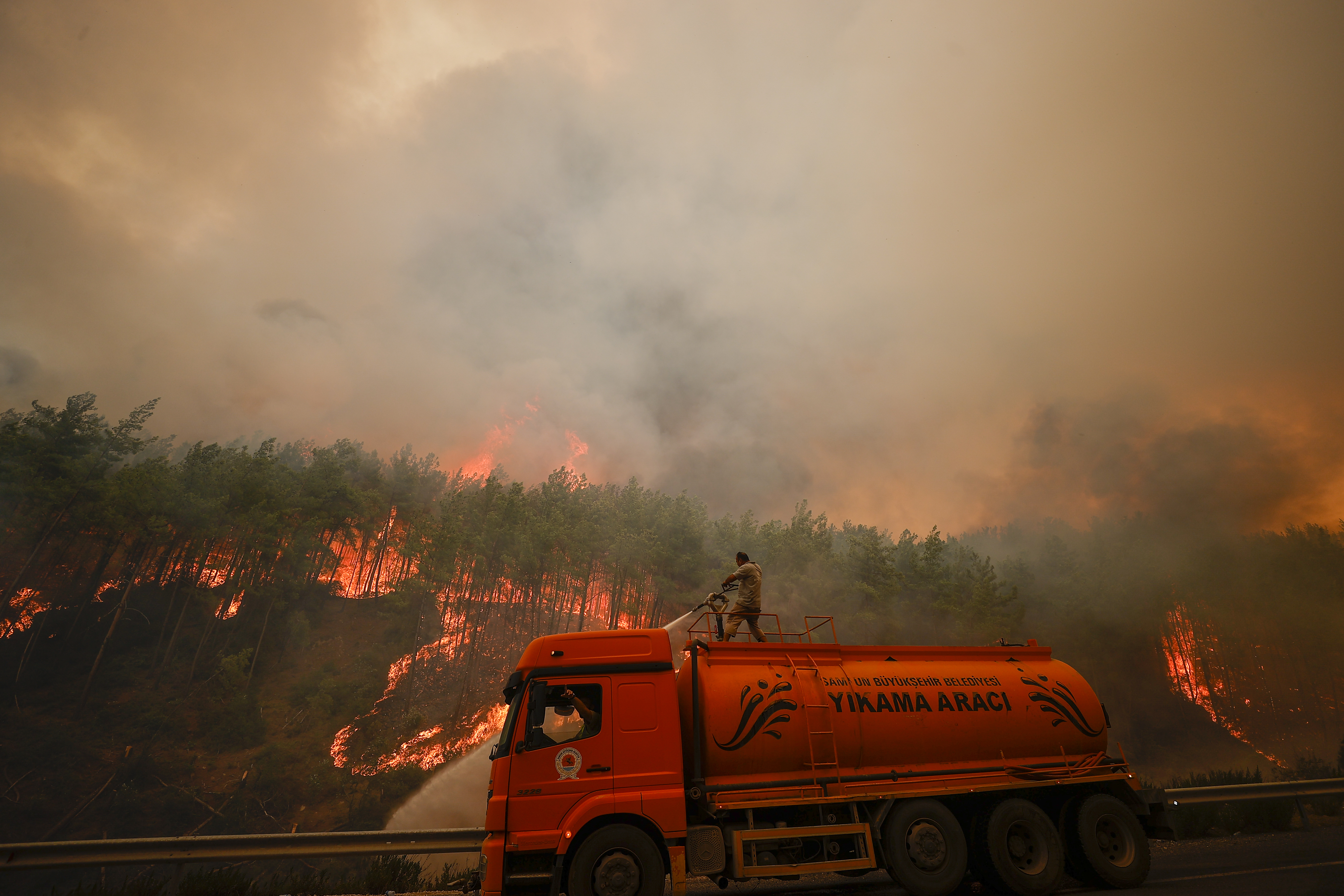 Firefighters battle against forest fires out in the Manavgat district of Antalya on Monday. Photo: Mustafa Ciftci/Anadolu Agency via Getty Images