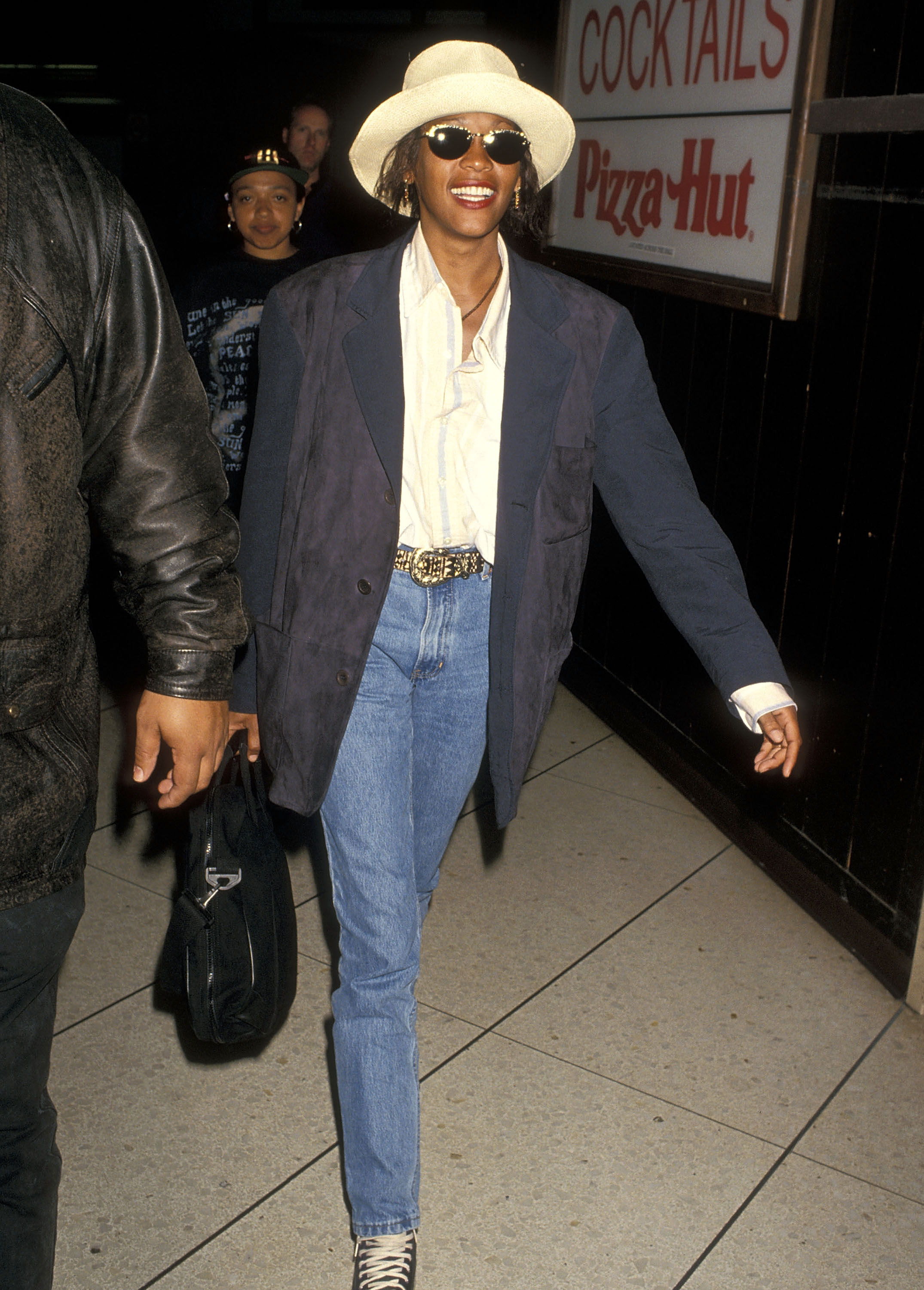 whitney houston walking into los angeles international airport in a blazer