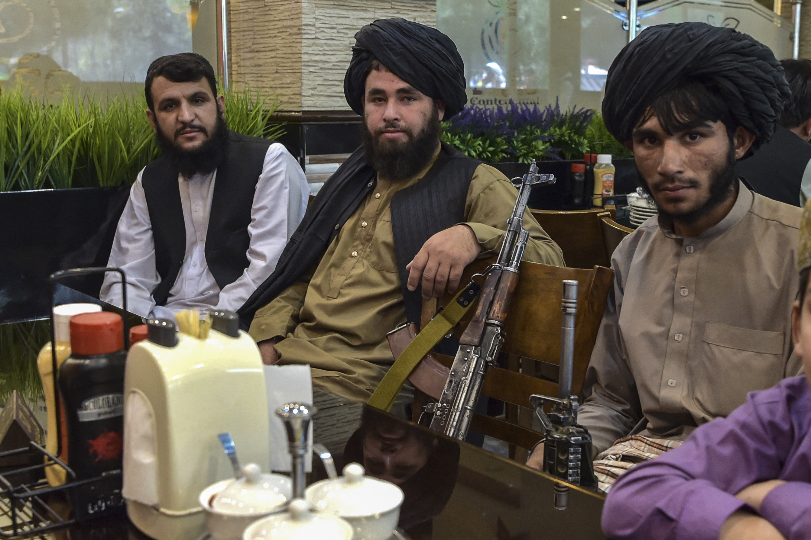 Prajurit Taliban menunggu makanan di sebuah restoran Kabul akhir Agustus lalu. Foto: Wakil Kohsar/AFP via Getty Images