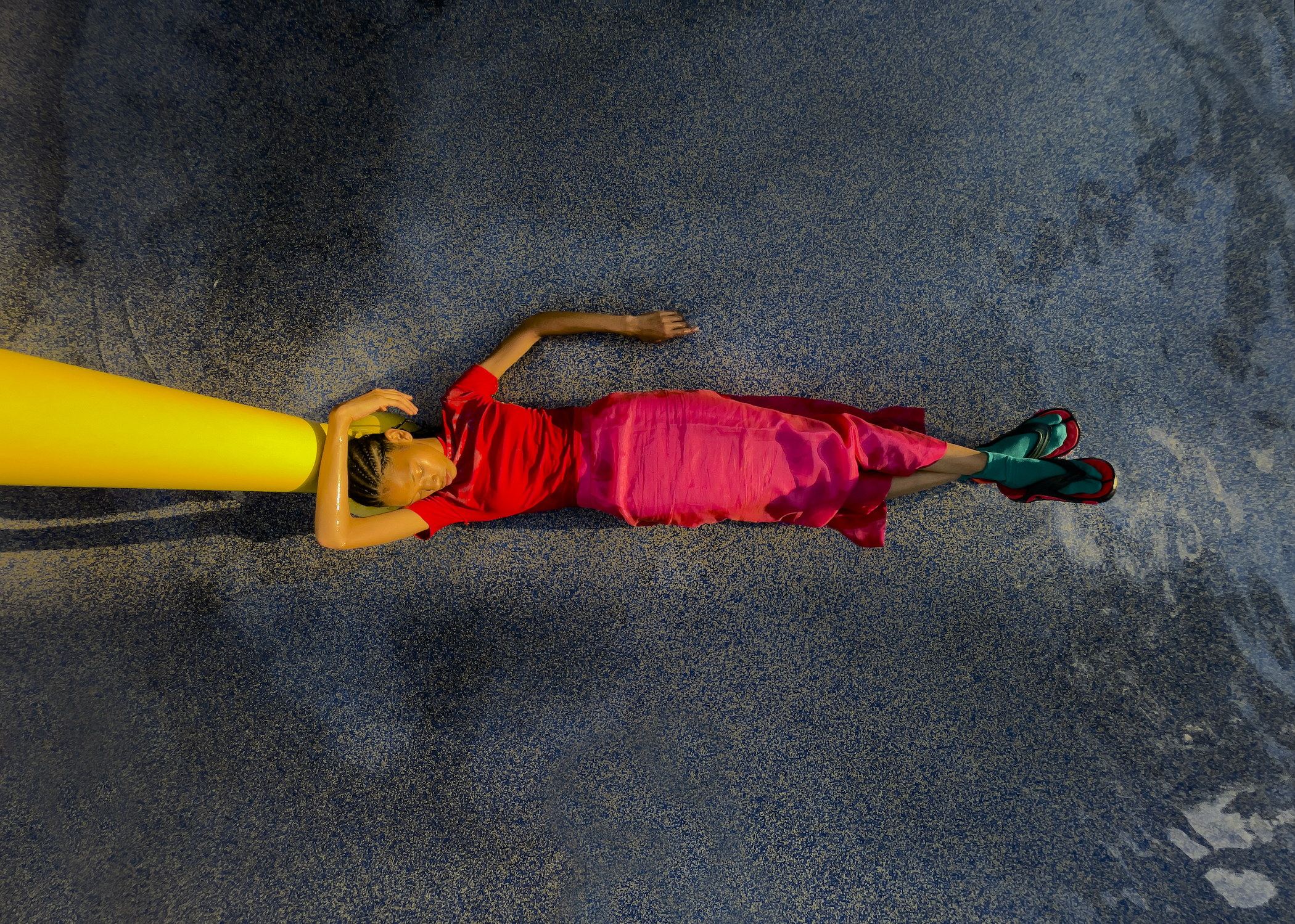 a portrait of a woman lying on the playground from above by arielle bobb-willis