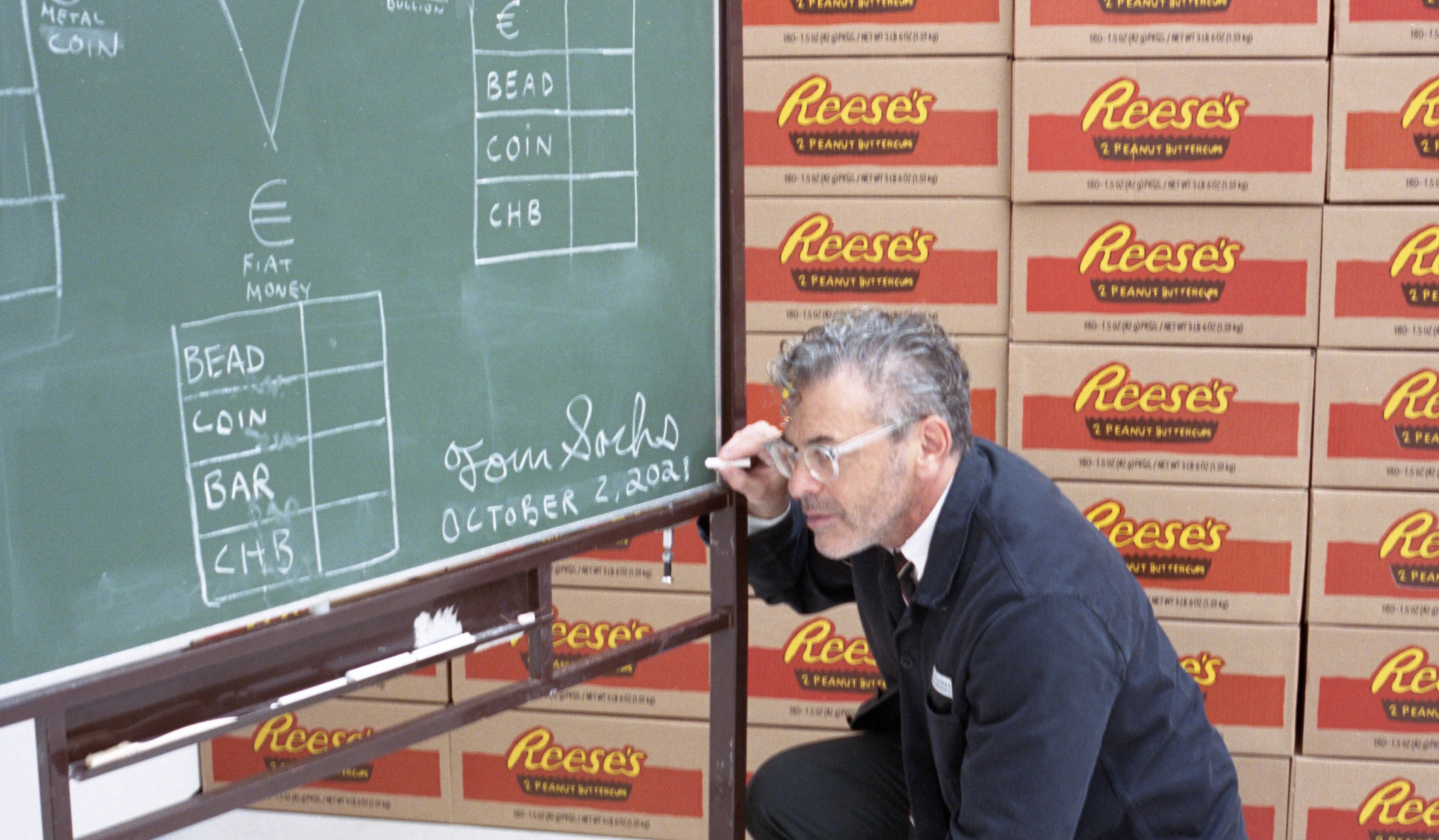 Tom Sachs by a chalkboard