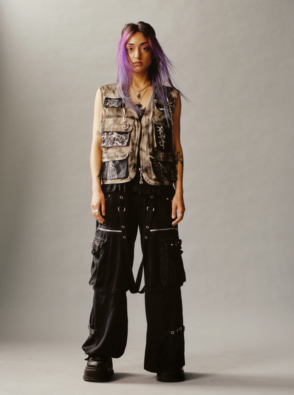 a Lola + Pani photograph of a model with violet hair wearing baggy skate trousers and a utility jacket 